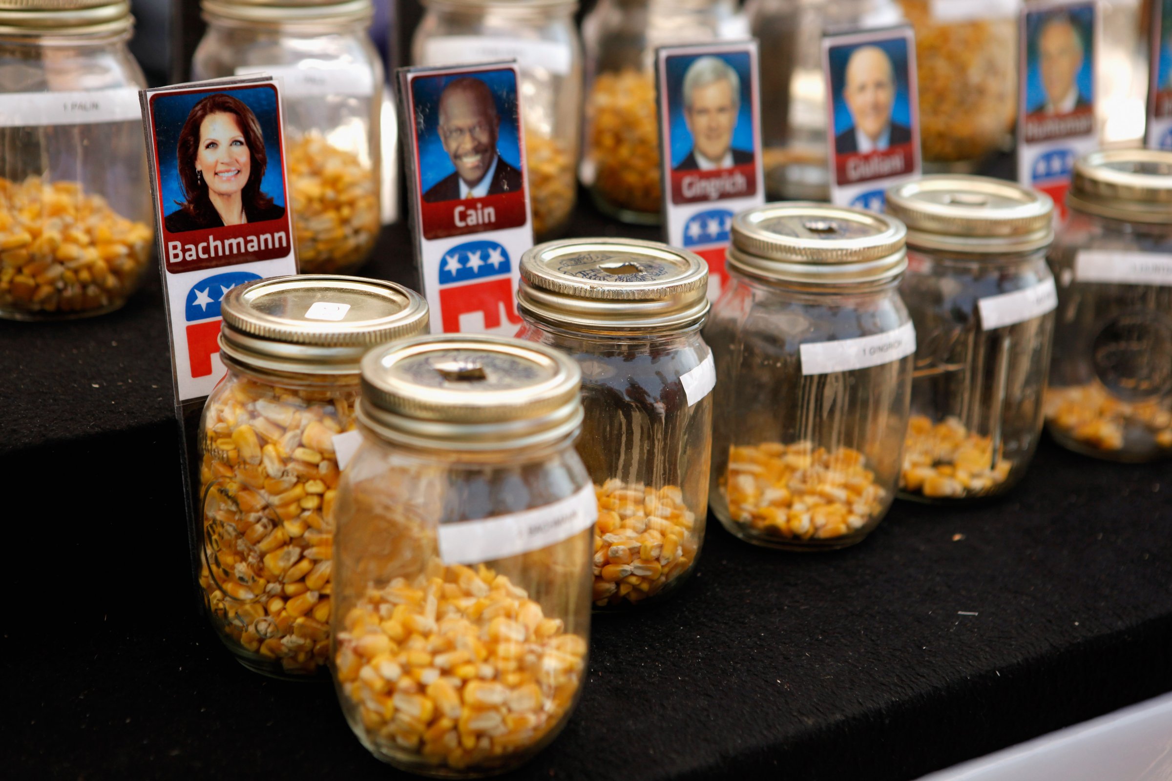 Fairgoers over the age of 18 are invited to drop one piece of corn into one of 14 jars with photos of their favorite Republican presidential candidate during the second day of the Iowa State Fair ahead of the Iowa Straw Poll on Aug. 12, 2011 in Des Moines, Iowa.