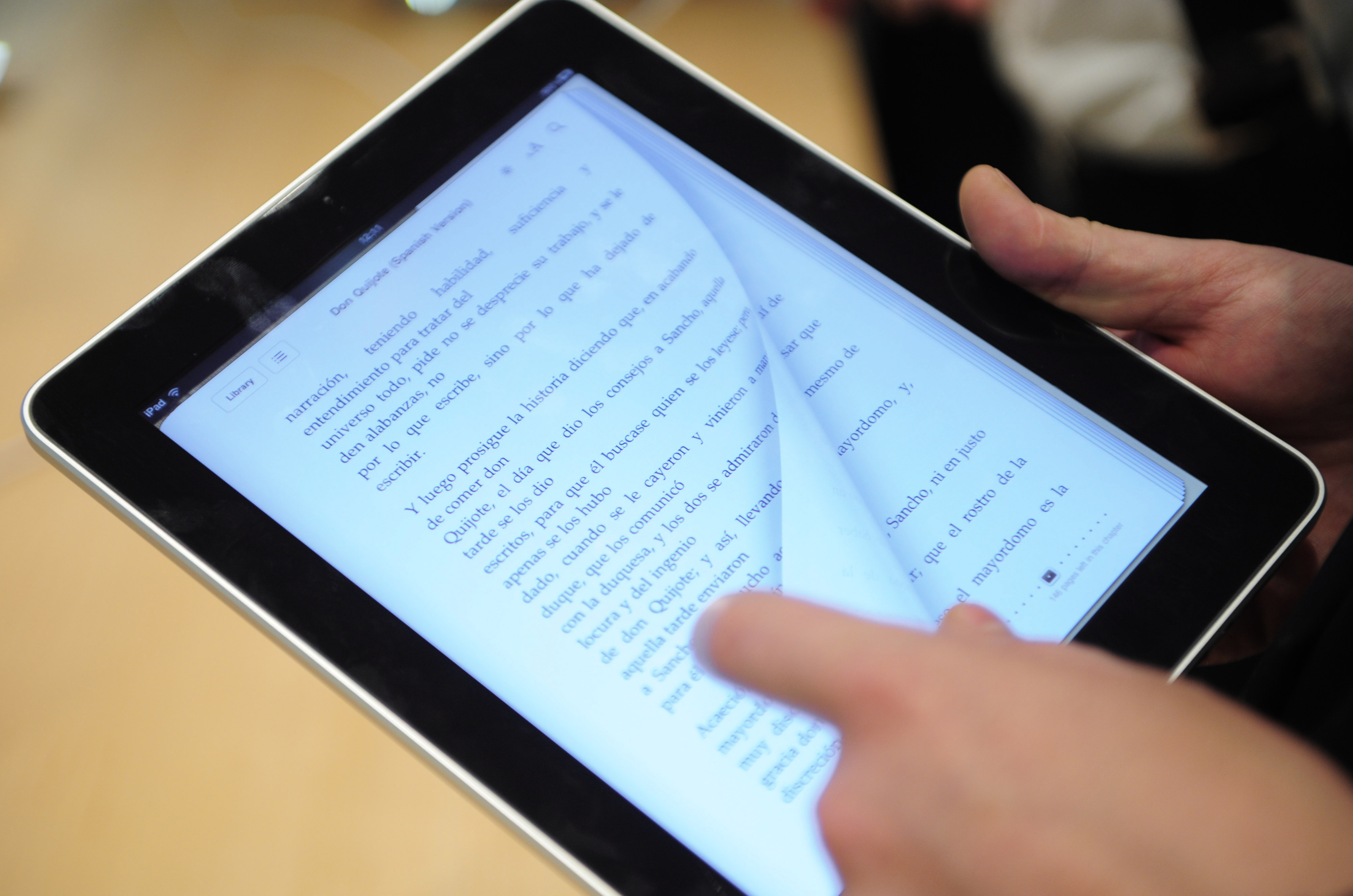 A customer is reading on an iPad at an Apple store Barcelona on May 28, 2010. (Manu Fernandez—AP)