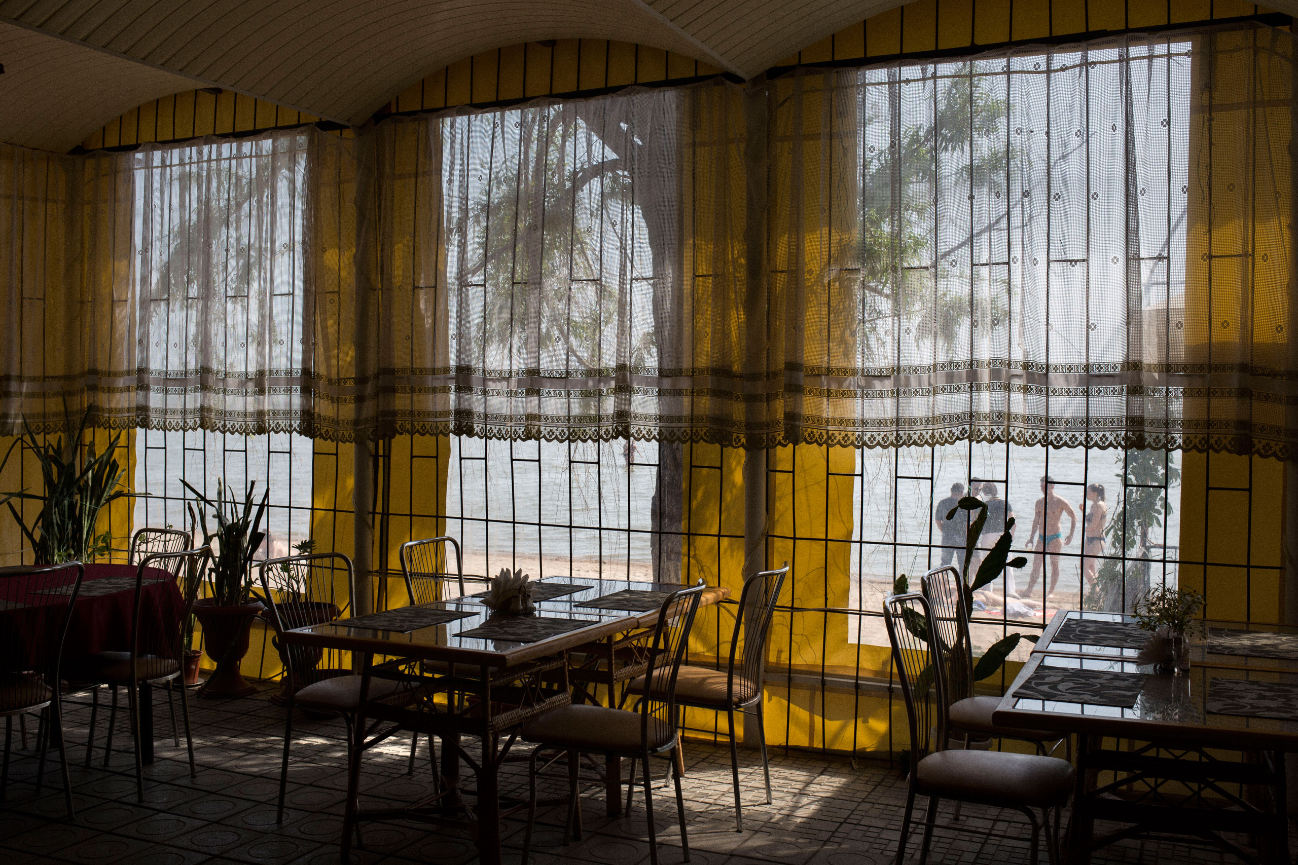 A restaurant that would otherwise be packed sites empty on the beach. Mariupol, Ukraine. May 24, 2015.