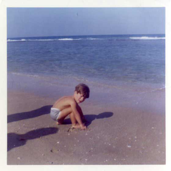John F. Kennedy Jr. plays with sand on the beach, April 1963.
