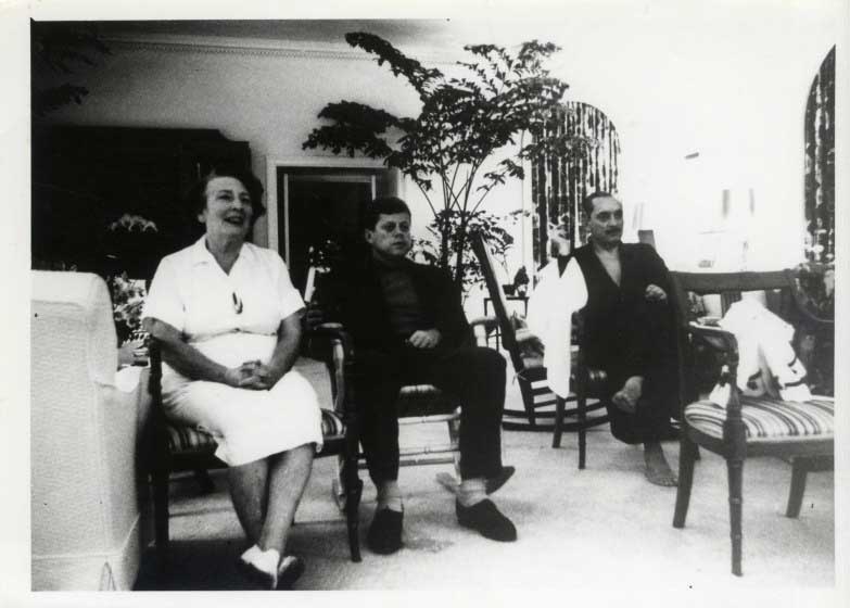 President John F. Kennedy sits next to White House nanny Maud Shaw.