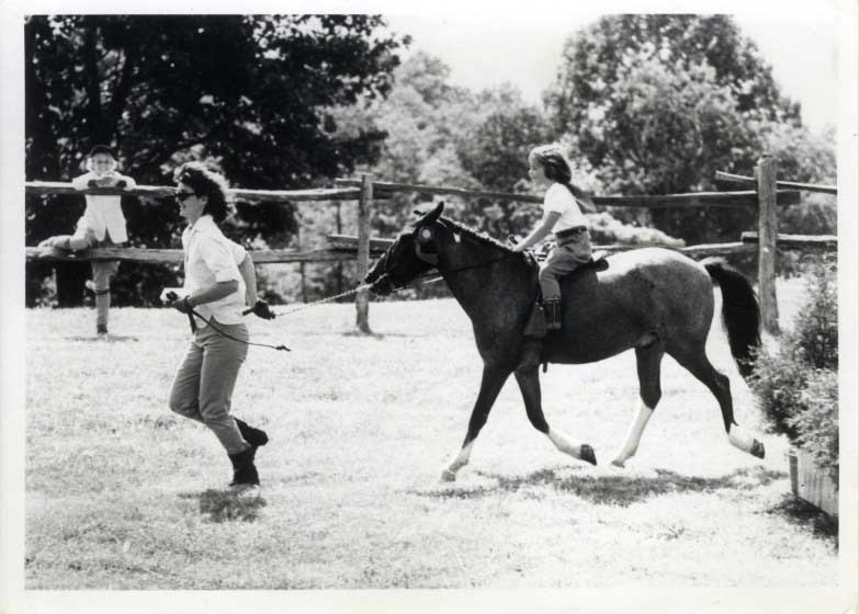 Jackie Kennedy leads the horse Macaroni, ridden by her daughter Caroline in Wexford, Va.