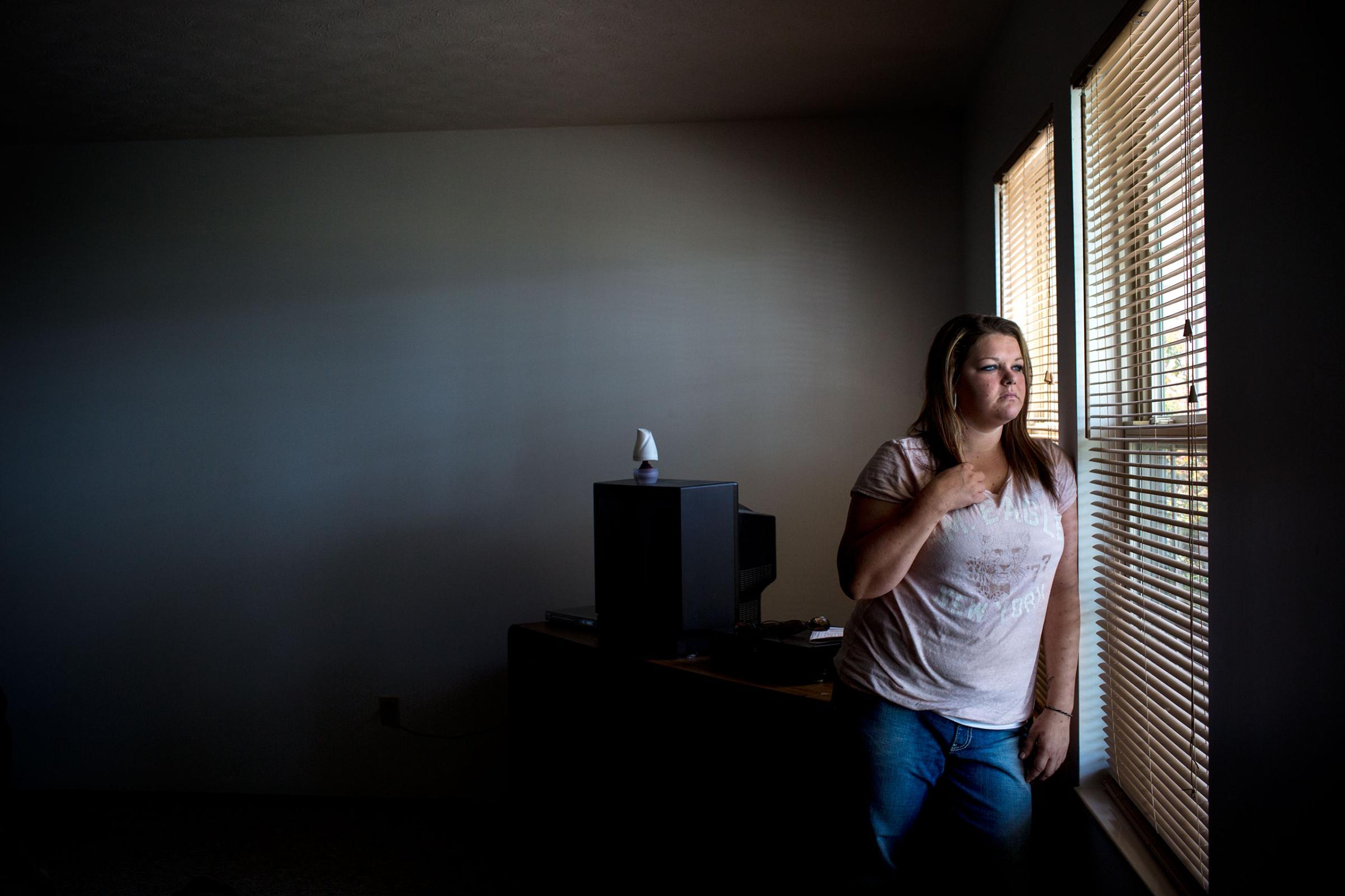 May 23, 2015, Austin, Indiana. Tiffany Turner poses for a portrait at her home. Tiffany Turner became addicted to Opana after the death of her husband and a long time pain killer problem. After losing custody of her children she quit drugs a month ago, and is now volunteering at the needle exchange and fighting to regain custody of her kids. Austin, Indiana has recently been rocked by the diagnosis of over 160 HIV cases in the small community. The majority of these cases have been found in users of Opana, a prescription pain killer which can be abused intravenously and is considered highly addictive. The city has recently opened a needle exchange program to provide clean syringes to the drug users and help to contain the outbreak. (Natalie Keyssar)