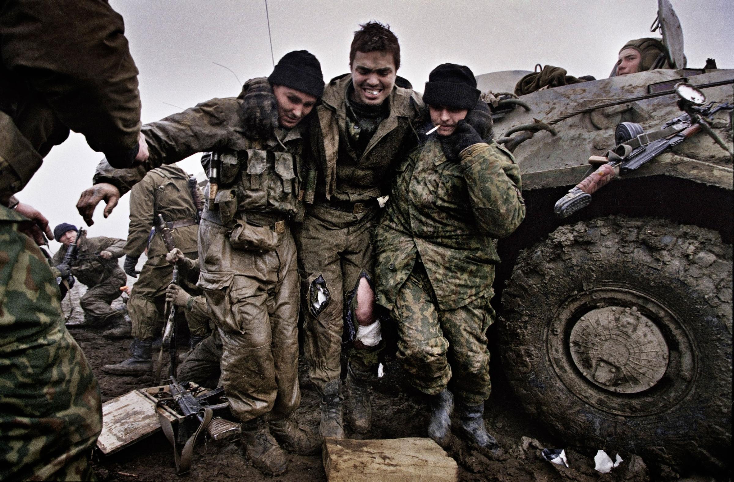 Russian marines help a wounded fellow soldier after being caught in an ambush near Tsentaroy, Checnya, Dec. 1999. Yuri Kozyrev—NOOR