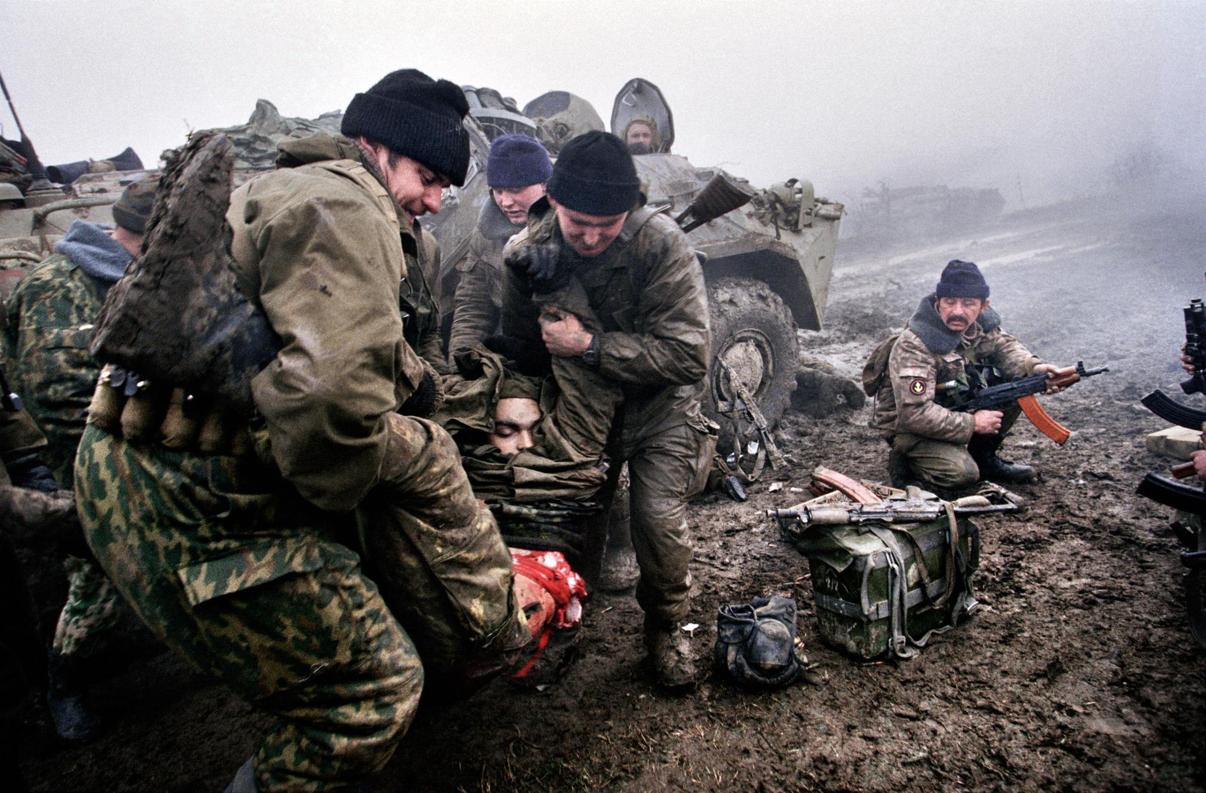 Marines carry a dead comrade during fighting in Tsentaroy , Chechnya, Dec 1999. In September of that year, Russian forces began military action against Chechen rebels. Yuri Kozyrev—NOOR
