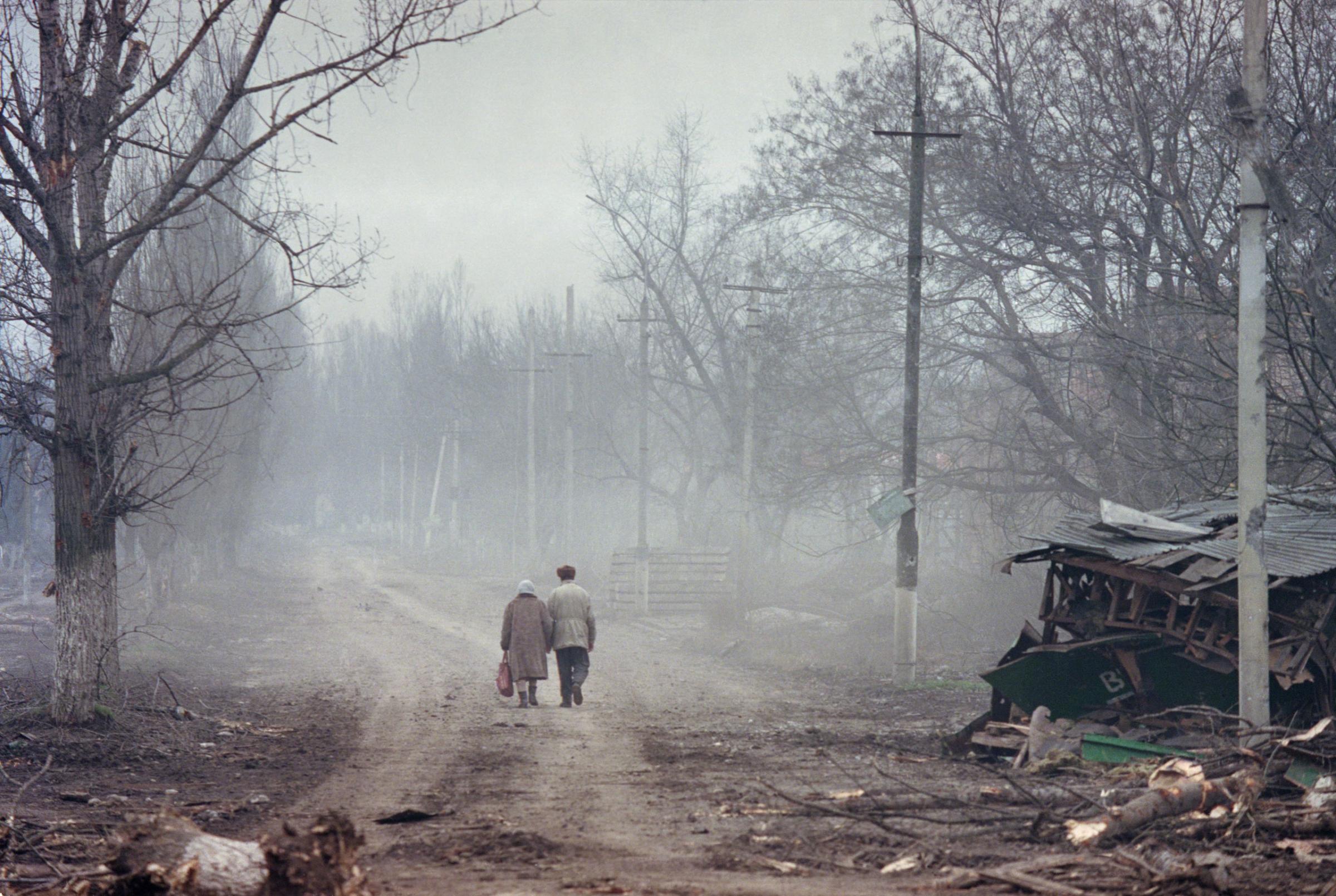 A couple walks through the ruins of Grozny, the capital of Chechnya, which was flattened by Russian air strikes in the second Chechen war, March 2002. Yuri kozyrev—NOOR