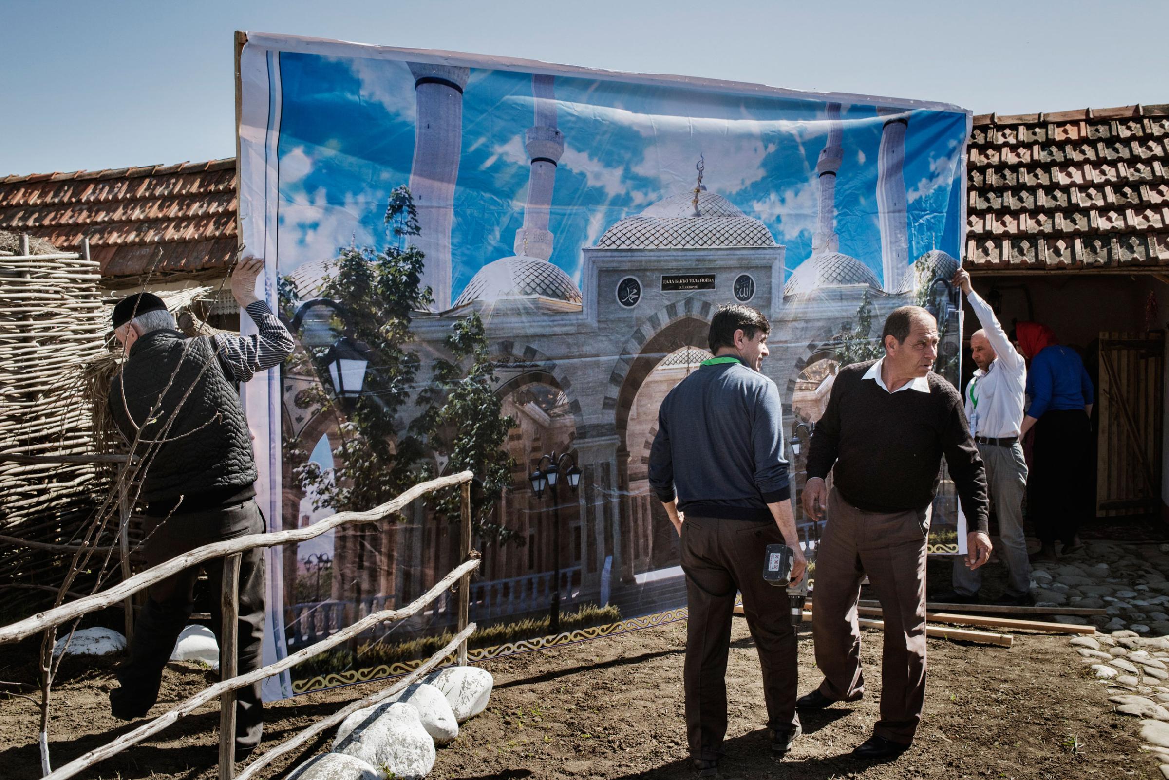 Workers set up their stand at a cultural festival near the town of Shali, Chechnya, April 18, 2015Yuri kozyrev—NOOR for TIME