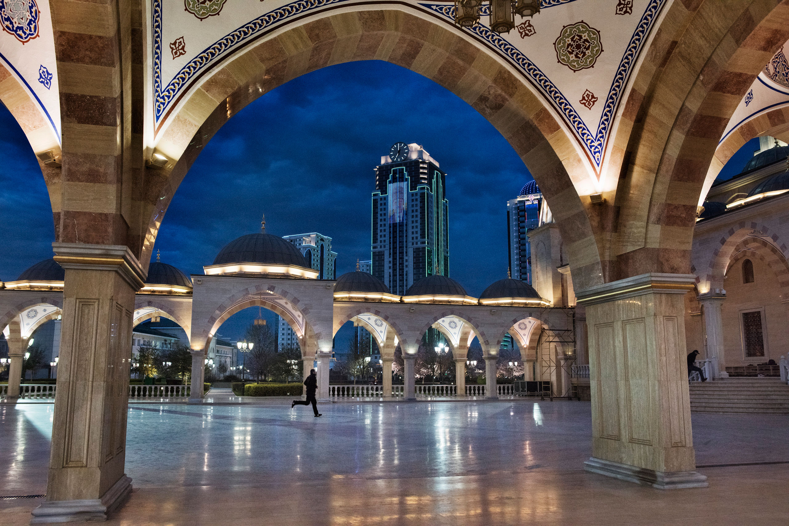 Worshipers hurry into the Heart of Chechnya Mosque for the evening prayer in Grozny, April 2015.