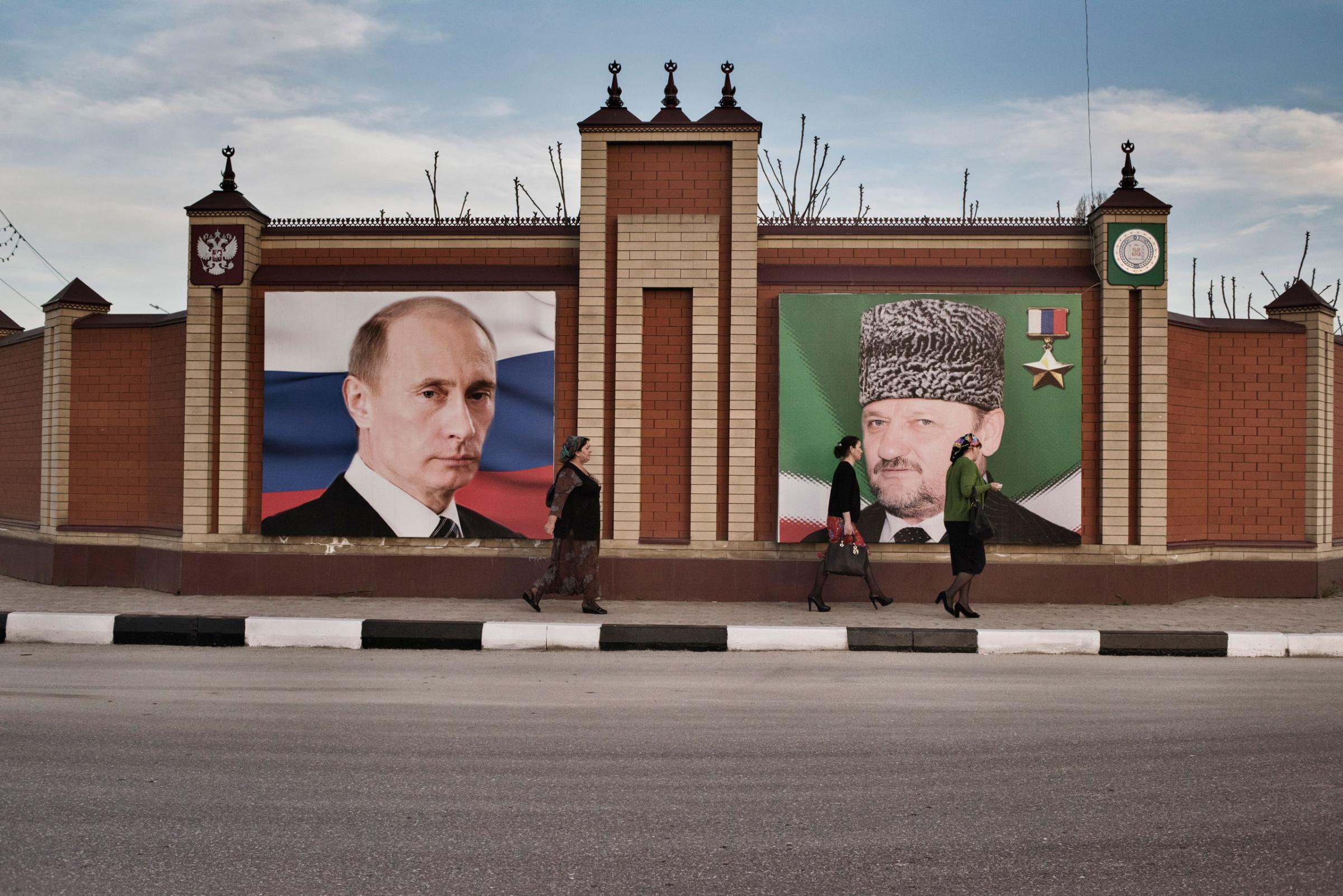 Women walk past a portrait of Russian President Vladimir Putin and the late President of Chechnya, Akhmad Kadyrov, He was the father of Chechnya's current leader, Ramzan Kadyrov, Grozny, Chechnya, April, 2015. Yuri kozyrev—NOOR for TIME