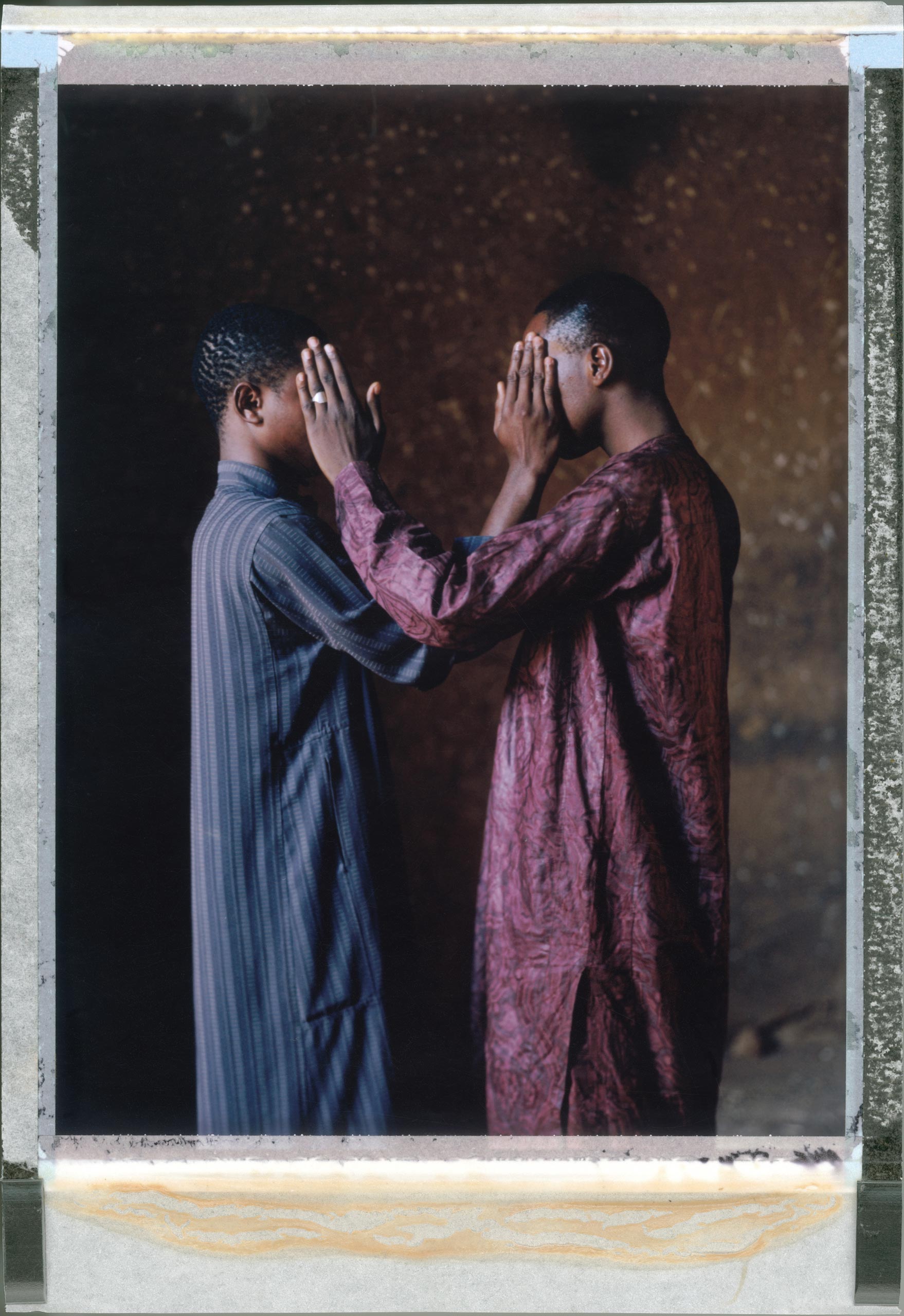 A posed posed portrait of Ishmel (left) and Gabriel (right) (not their real names) who are gay. In December 2013 they were taken from their homes by a vigilante group aligned to Bauchi City Sharia Courts who suspected them of being gay. They slapped and beat them with electric cables. He was held in prison for over 40 days. He made several appearances at the Sharia Court. They were lashed 15 times with a horse whip, but then acquitted of committing homosexual acts as there were no witnesses to the crime. Sodomy is punishable by death under Sharia Law but requires four witnesses. Since Nigeria’s president signed a harsh law criminalizing homosexuality throughout the country, arrests of gay people have multiplied, advocates have been forced to go underground, some people fearful of the law have sought asylum overseas and news media demands for a crackdown have flourished. Three young men were recently flogged 20 times in a northern Nigerian court room for being gay. Some consider them lucky. The penalty for gay sex under local Islamic law is death by stoning. Nigeria, April 2014.   While many countries around the world are legally recognizing same-sex relationships, individuals in nearly 80 countries face criminal sanctions for private consensual relations with another adult of the same sex. Violence and discrimination based on sexual orientation or gender expression is even more widespread. Africa is becoming the worst continent for Lesbian, Gay, Bi-sexual, Transgender, Queer, Inter-sex (LGBTQI) individuals. More than two thirds of African countries have laws criminalizing consensual same-sex acts. In some, homosexuality is punishable by death. In Nigeria new homophobic laws introduced in 2013 led to dramatic increase in attacks. Under Sharia Law, homosexuality is punishable by death, up to 50 lashes and six months in prison for woman; for men elsewhere, up to 14 years in prison. Same sex acts are illegal in Uganda. A discriminatory law was passed then struck down