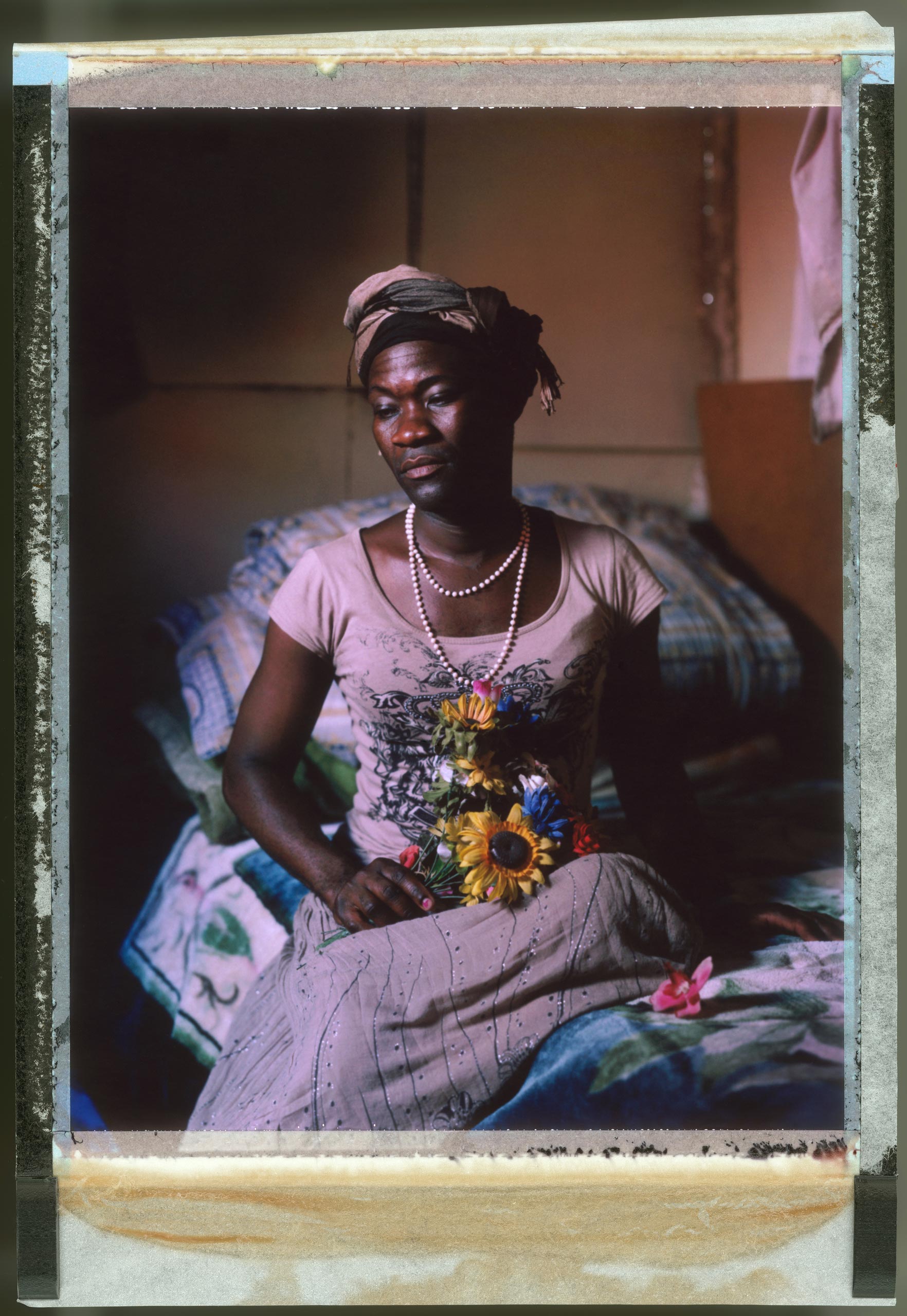 A posed portrait of Tiwonge Chimbalanga from Malawi. In 2009 Steven Monjeza Soko and Tiwonge Chimbalanga were arrested in their home country of Malawi and in 2010 they were both charged with buggery and permitting buggery, as well as with the offence of indecent practices between males in accordance with sections 153 and 156 of the Malawian Penal Code. Convicted, the two men were sentenced to the maximum penalty of fourteen years. According to the sentencing magistrate, the severity of the sentence was justified to protect Malawian society: “I will give you a scaring sentence so that the public be protected from people like you, so that we are not tempted to emulate this horrendous example.” This judgement took place in spite of Malawi’s own constitution and it being a signatory state to a number of human rights treaties. Consequently, the case attracted an international outcry and both men were later pardoned on condition that they do not have any future contact with each other. Following release, fearing for her safety, Tiwonge fled to South Africa. November 2014.  While many countries around the world are legally recognizing same-sex relationships, individuals in nearly 80 countries face criminal sanctions for private consensual relations with another adult of the same sex. Violence and discrimination based on sexual orientation or gender expression is even more widespread. Africa is becoming the worst continent for Lesbian, Gay, Bi-sexual, Transgender, Queer, Inter-sex (LGBTQI) individuals. More than two thirds of African countries have laws criminalizing consensual same-sex acts. In some, homosexuality is punishable by death. In Nigeria new homophobic laws introduced in 2013 led to dramatic increase in attacks. Under Sharia Law, homosexuality is punishable by death, up to 50 lashes and six months in prison for woman; for men elsewhere, up to 14 years in prison. Same sex acts are illegal in Uganda. A discriminatory law was passed then struck down and homop