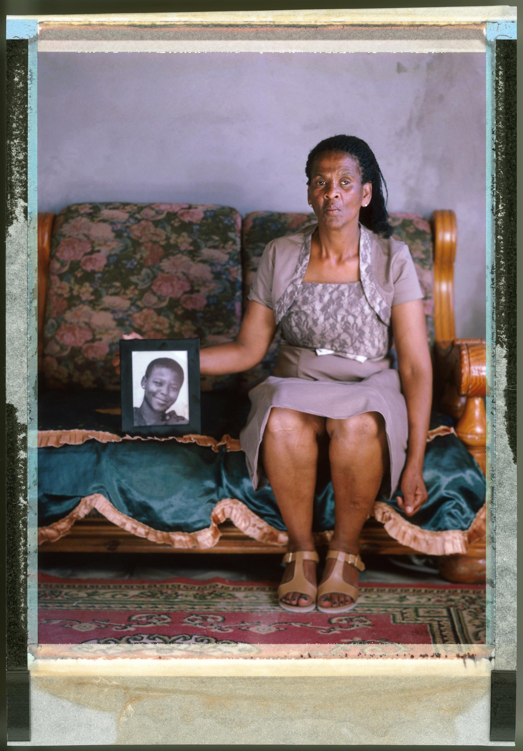 Boniwe Tyatyeka
                              Cape Town, South Africa, Nov. 2014
                              Boniwe Tyatyeka holds a framed photograph of her daughter Nontsikelelo (also called Ntsikie) who disappeared in September 2010. One year later, her decomposed body was found in a neighbor’s dustbin; she had been raped, beaten and strangled to death. According to Tyatyeka, the neighbor said he had done it to change her because she was a lesbian.
                              
                              South Africa was the first country on the continent to legalize same-sex marriage and its constitution guarantees LGBT rights, but social stigma around homosexuality remains. “Nitsikie was a child with dreams,” Boniwe says. “Even now when I’m on the go, I am always looking out like I will hopefully see Ntsikie.”