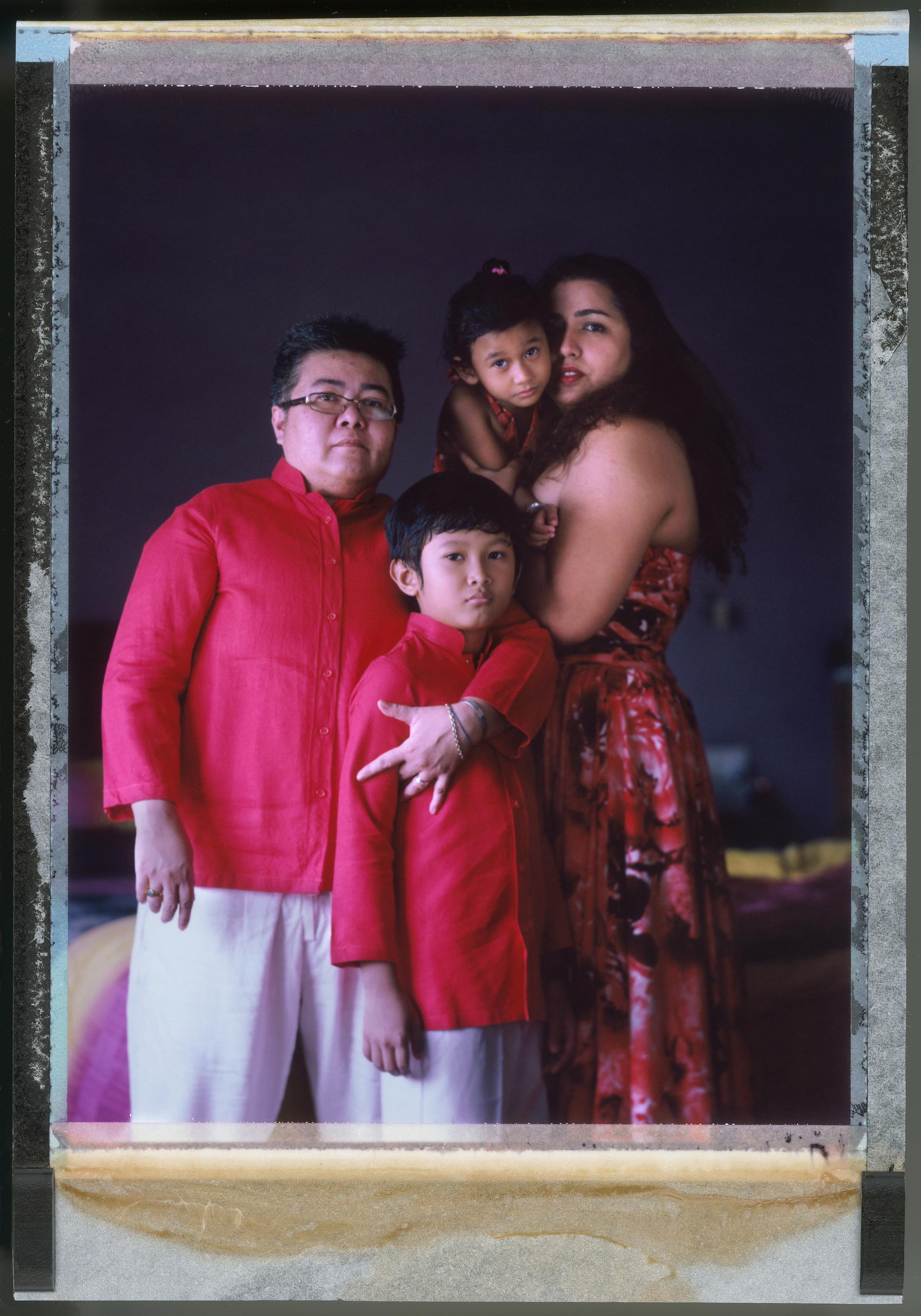 Mitch Yusmar
                              Kuala Lumpur, Malaysia, Jan. 2015
                              47-year-old transgender man Mitch Yusmar is photographed at home in Malaysia with his partner of 17 years, Lalita Abdullah, and their adopted children Izzy and Daniya.
                              
                              The Malaysian government retains a penal code criminalizing sodomy that dates back to the colonial era. It can include a 20-year-prison sentence and even corporal punishment. Yusmar’s relationship with his partner is not legally recognized and they live in fear that their family could be torn apart if something happened to Abdullah, who is the only legally recognized parent.
                              
                              “The core of our being is our family,” he says. “It can become very frustrating that we need to work doubly hard to ensure that our basic rights are looked after. But we have hope that some day things will be better.”