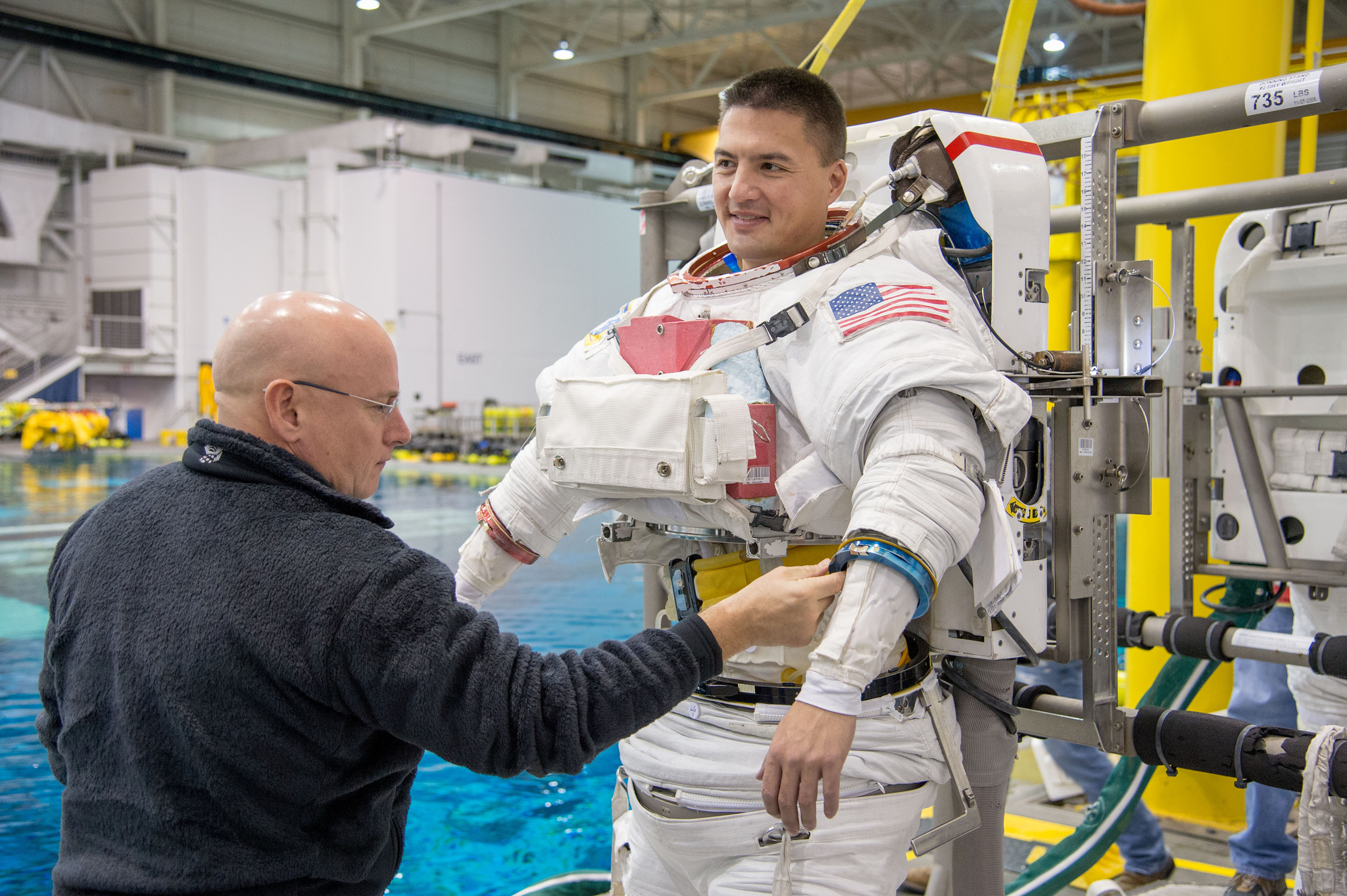 Preparing to make a house call: Scott Kelly, currently aboard the space station for a one-year stay, checks out spacewalk suit of space doc Kjell Lindgren, who blasts off next month (NASA)