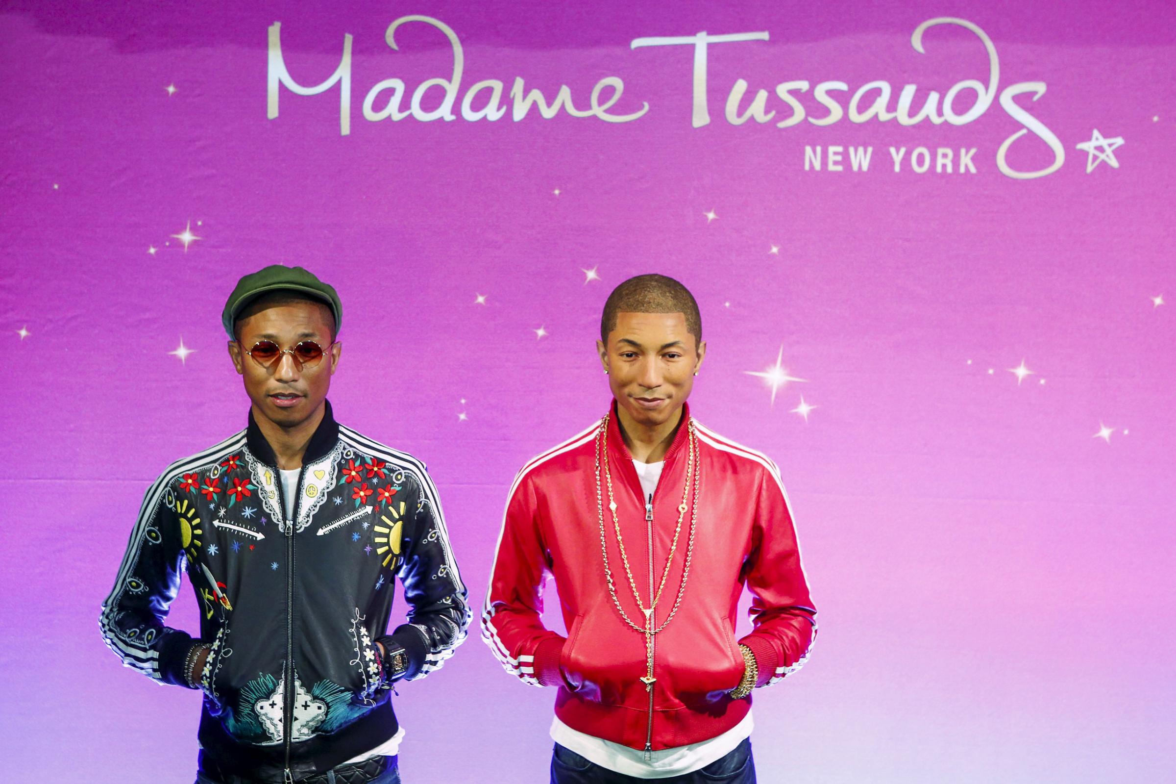 Musician Williams poses next to his wax double at Madame Tussauds in New York