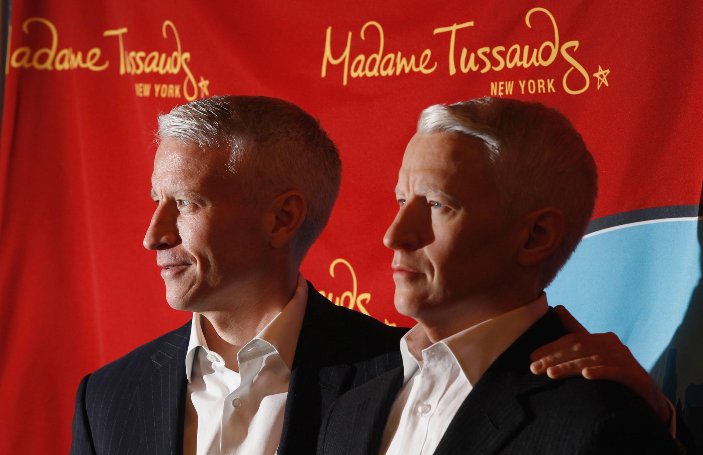 Television journalist Anderson Cooper poses with his wax figure as it is unveiled at Madame Tussauds in New York,