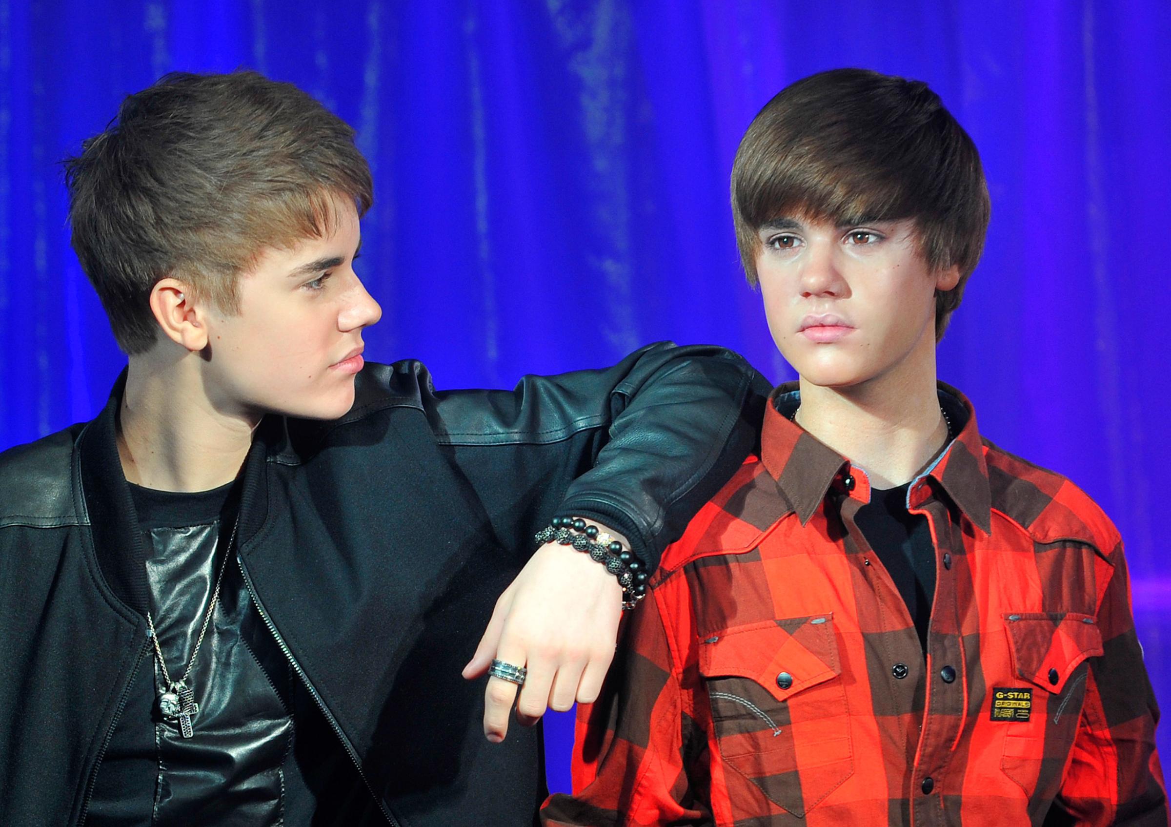 Canadian singer Bieber poses with a waxwork model of himself during an official unveiling at Madame Tussauds wax museum in central London