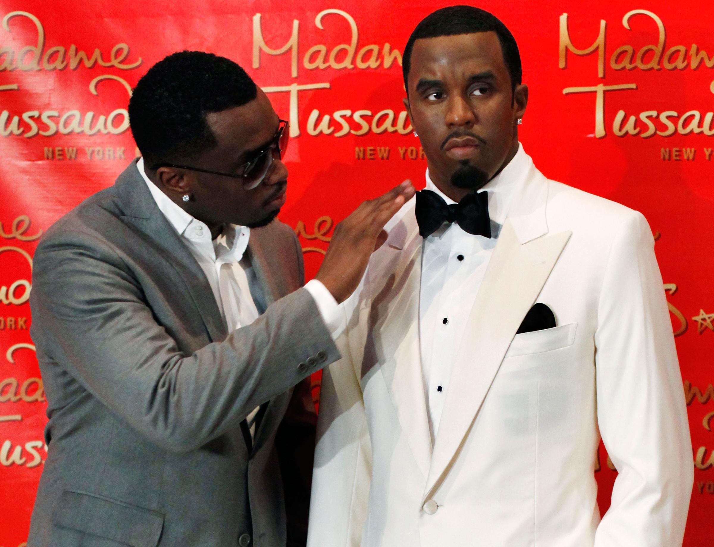 Sean "Diddy" Combs touches his wax figure at Madame Tussauds in New York