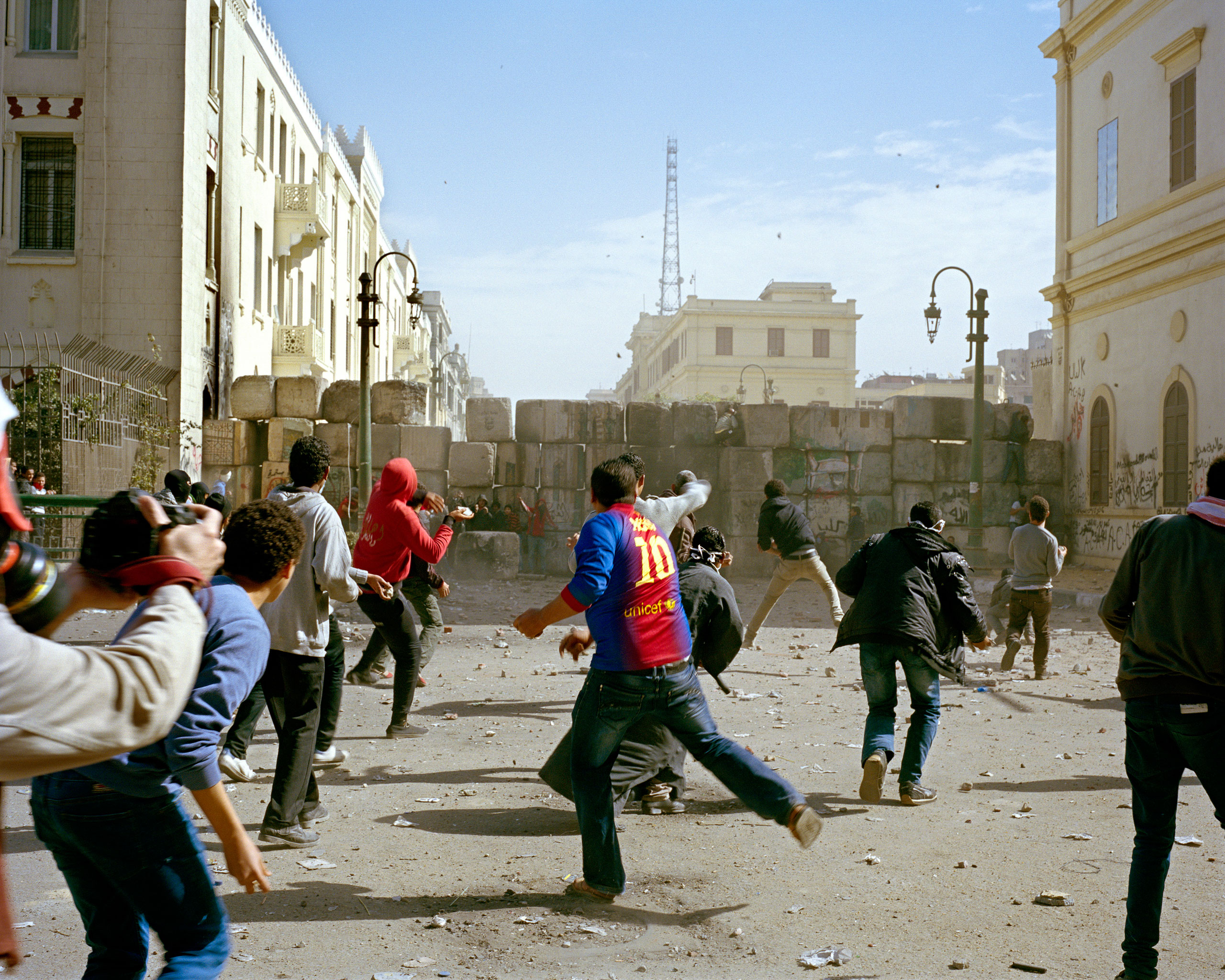 Cairo, second anniversary of the Egyptian Revolution, 2013Demonstrators throw stones over a barrier erected between protesters and armed officers.