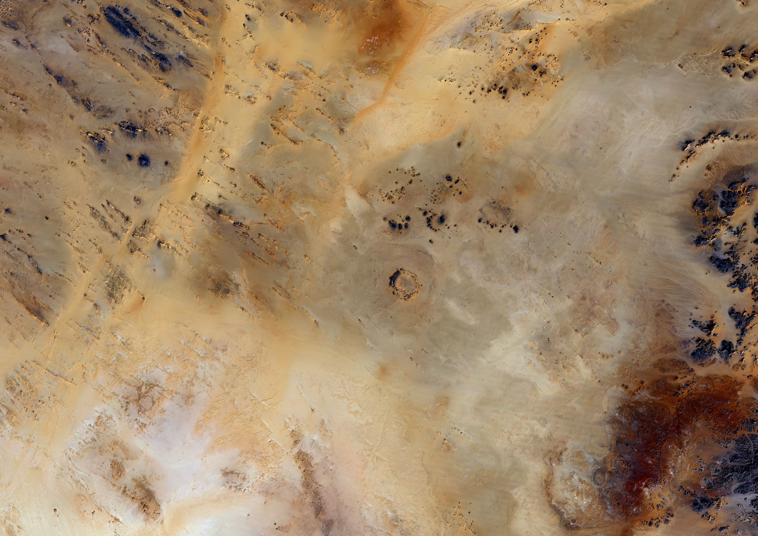 The Oasis crater North of Koufra Oasis in Libya. It is less than 120 million years old and was thought to have a diameter of roughly 18 km post-impact.