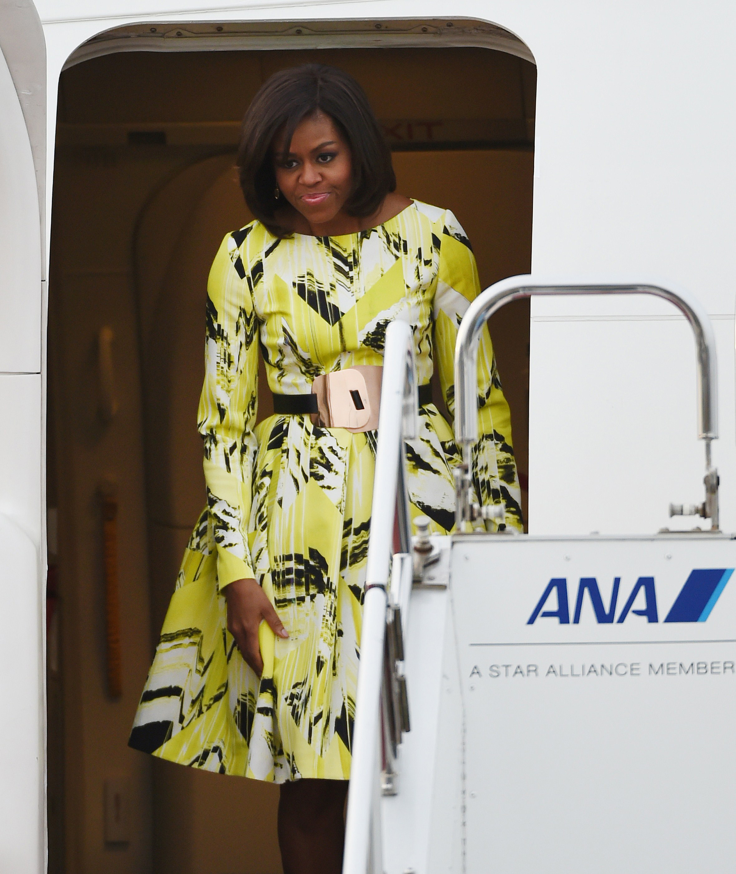 First Lady Michelle Obama exits the plane upon her arrival at Haneda International Airport in Tokyo on March 18, 2015.