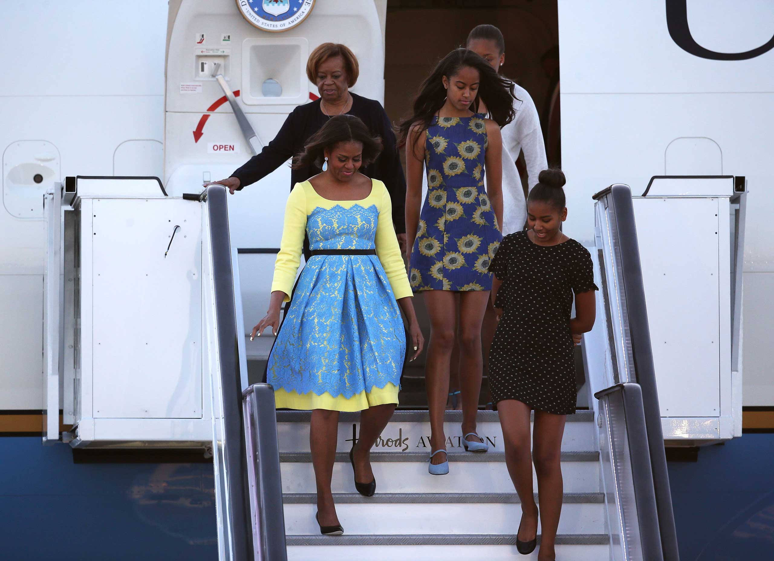 First Lady Michelle Obama arrives with daughters Malia Obama (C) and Sasha Obama (R) and her mother  Marian Robinson at Stanstead airport in London on June 15, 2015.