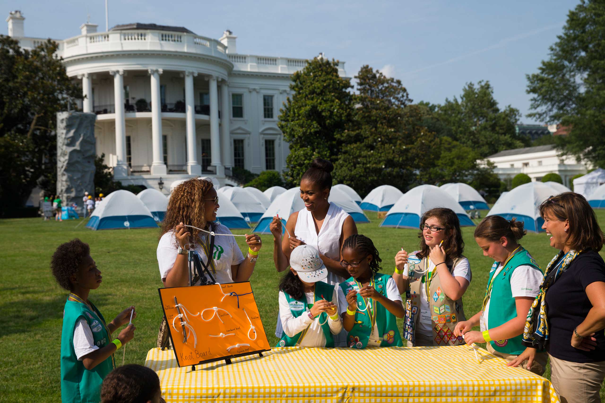 First lady Michelle Obama participates in a knot tying station during a Lets Move! event with Girl Scouts on the South Lawn of the White House in Washington, on June 30, 2015. (Evan Vucci—AP)