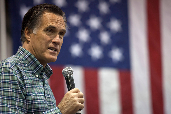 Former Massachusetts Gov. Mitt Romney addresses the crowd during a rally for Republican Senate candidate Dan Sullivan at a PenAir airplane hangar on November 3, 2014 in Anchorage, Alaska.