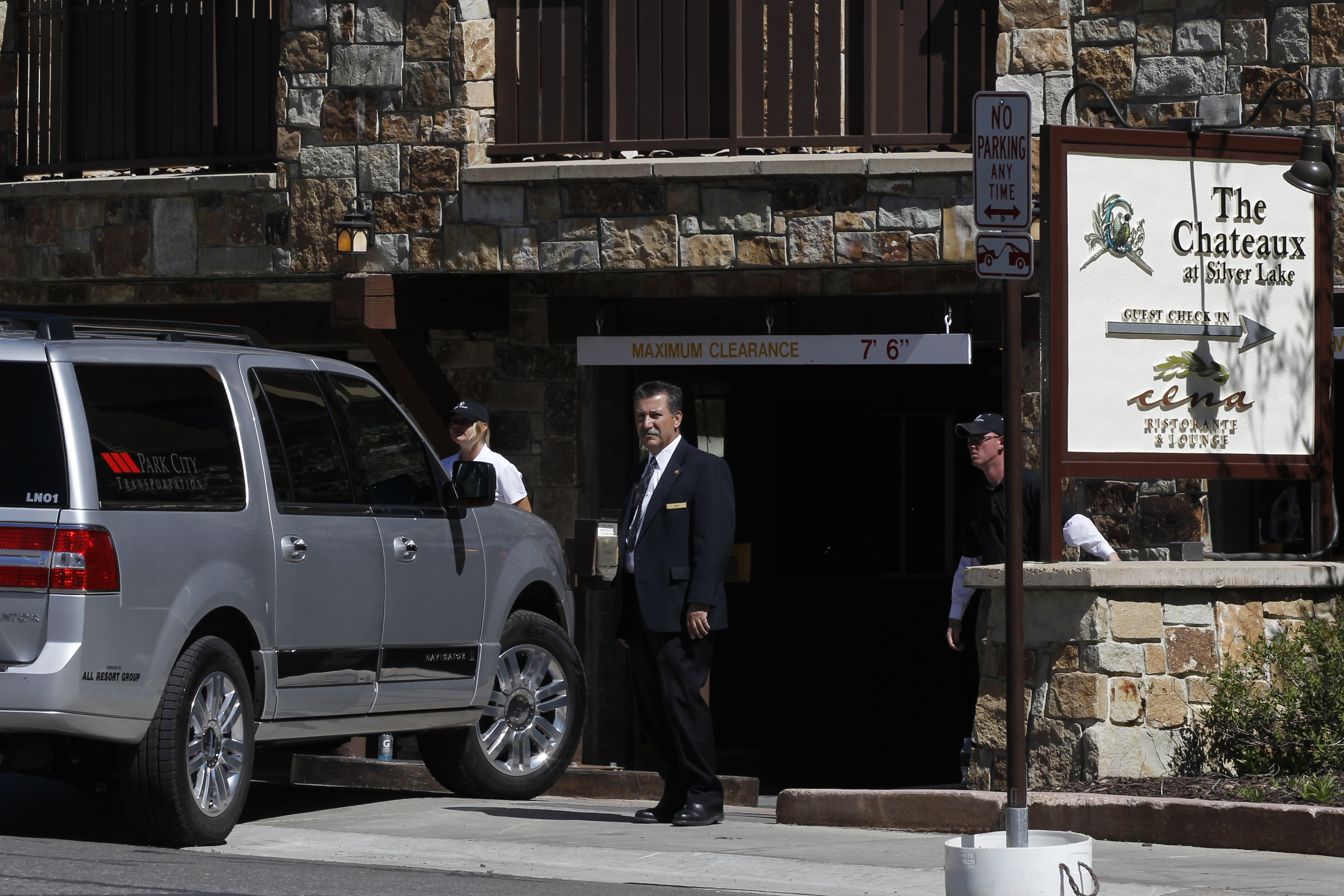 Security officials stand watch as cars enter a garage at a private 2012 donors' conference for Republican presidential candidate Mitt Romney at The Chateaux at Silver Lake at Deer Valley Resort in Park City, Utah. (Charles Dharapak—AP)