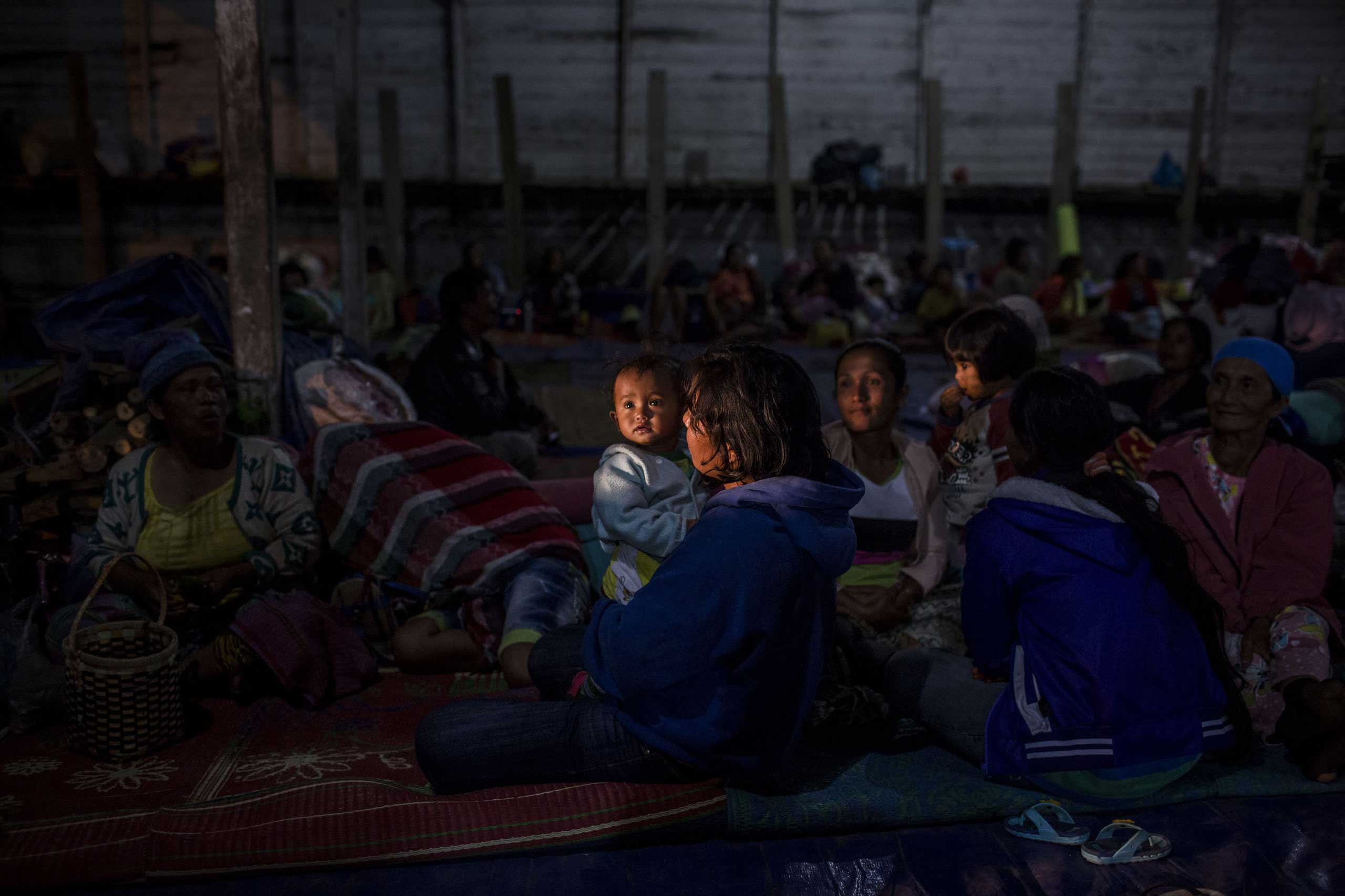 Villagers rest inside a temporary shelter in Sukanalu village, North Sumatra, Indonesia on June 16, 2015.