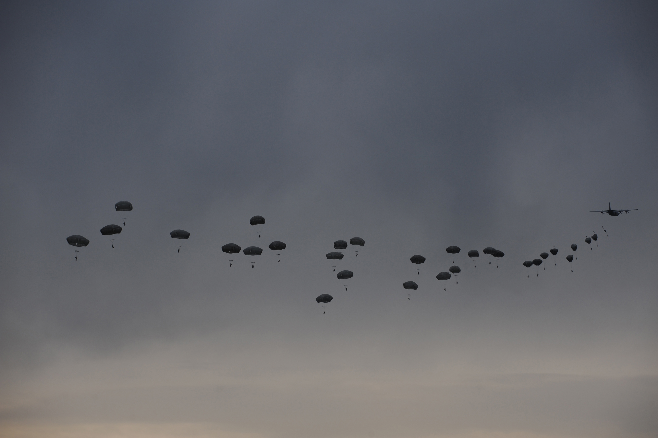 An airdrop of American soldiers in the 173rd Airborne, First Battalion, 503 Infantry Regiment parachute in from a C-130 during an airfield seizure exercise on the Swidwin Airfield in Poland on June 16, 2015.