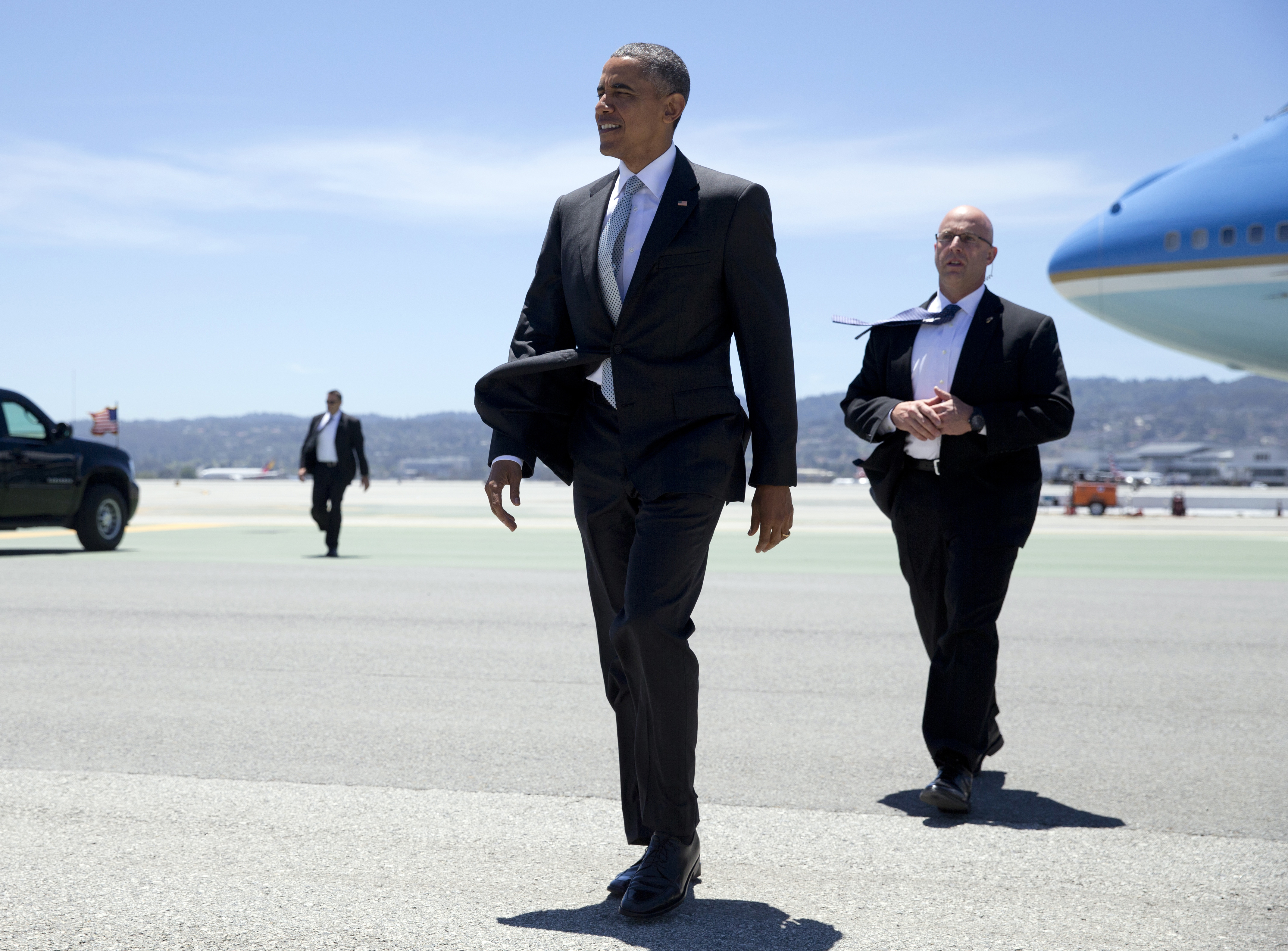 President Barack Obama walks across the tarmac to greet people as he arrives on Air Force One at San Francisco International airport June 19, 2015. (Carolyn Kaster—AP)