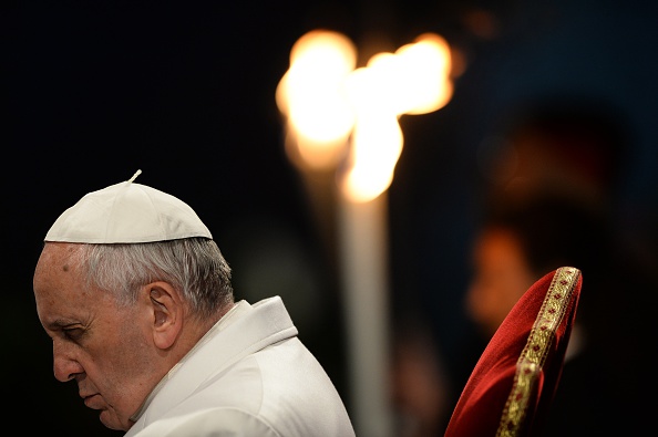 Pope Francis prays during the Way of the Cross torchlight procession at the Colosseum on Good Friday on April 3, 2015 in Rome. (FILIPPO MONTEFORTE—AFP/Getty Images)