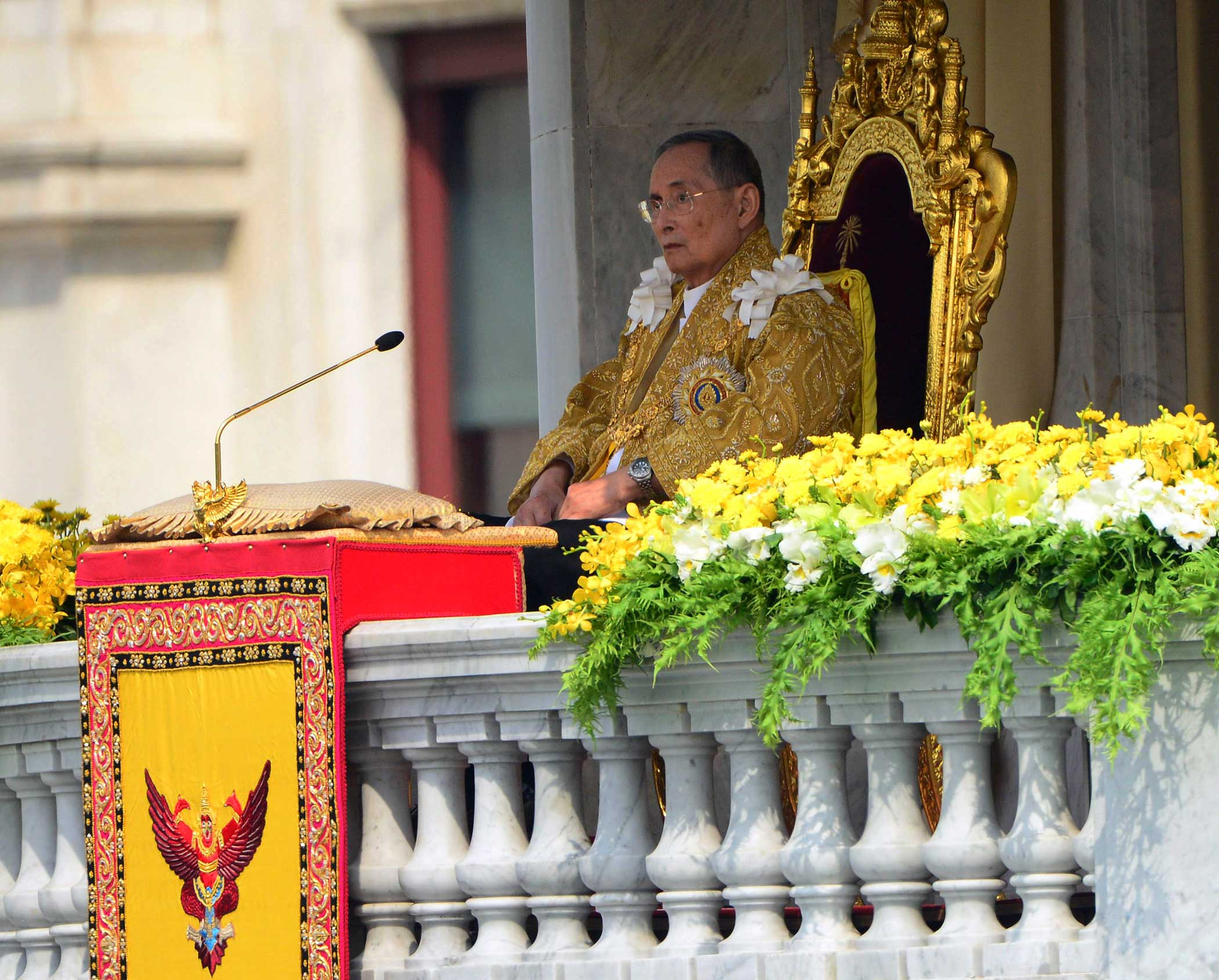 Thai King Bhumibol Adulyadej appears to address a crowd from the balcony at the Anantha Samakhom Throne Hall in Bangkok, Thailand, during his 85th birthday celebration on Dec. 5, 2012.