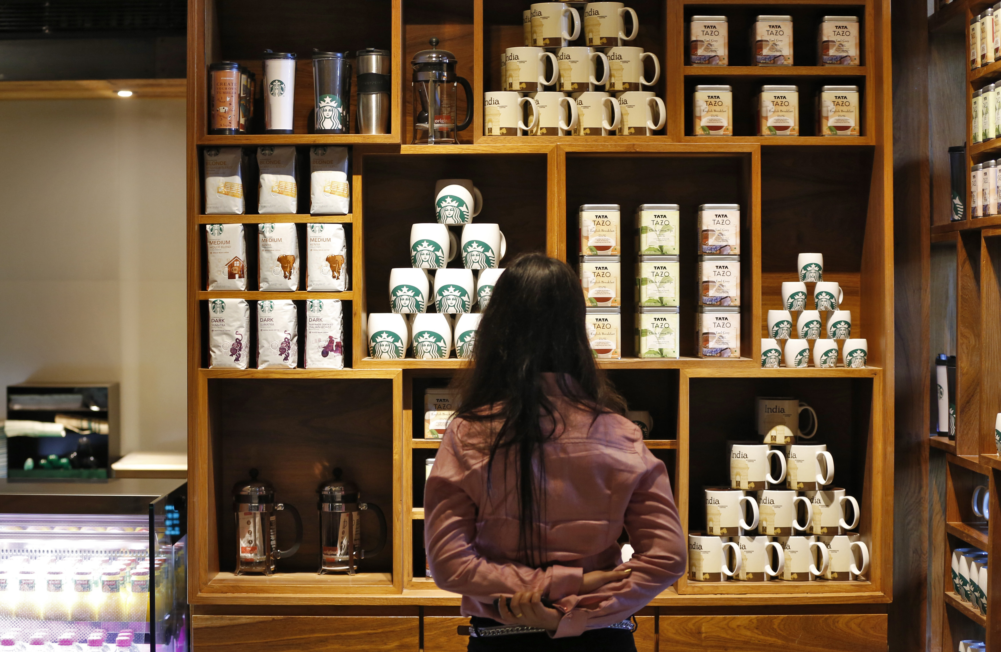 A visitor looks at products on display during the launch of the first Starbucks store in New Delhi, Feb. 6, 2013 (Adnan Abidi—Reuters)