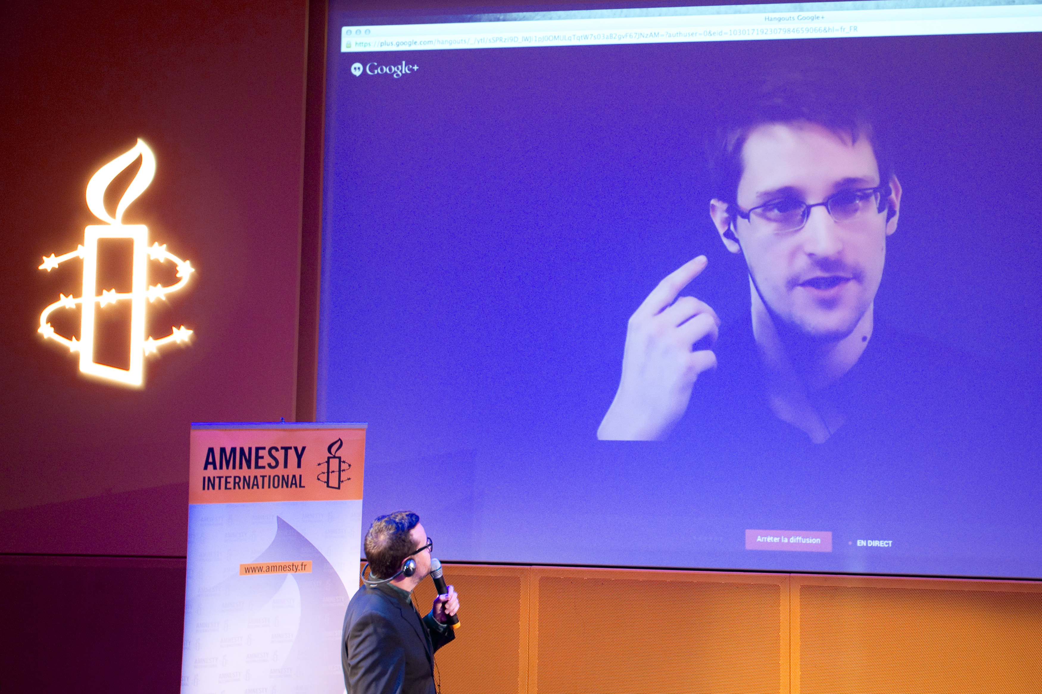 Former U.S. National Security Agency contractor Edward Snowden, who is in Moscow, is seen on a giant screen during a live video conference for an interview as part of Amnesty International's annual Write for Rights campaign at the Gaite Lyrique in Paris December 10, 2014 (Charles Platiau—Reuters)