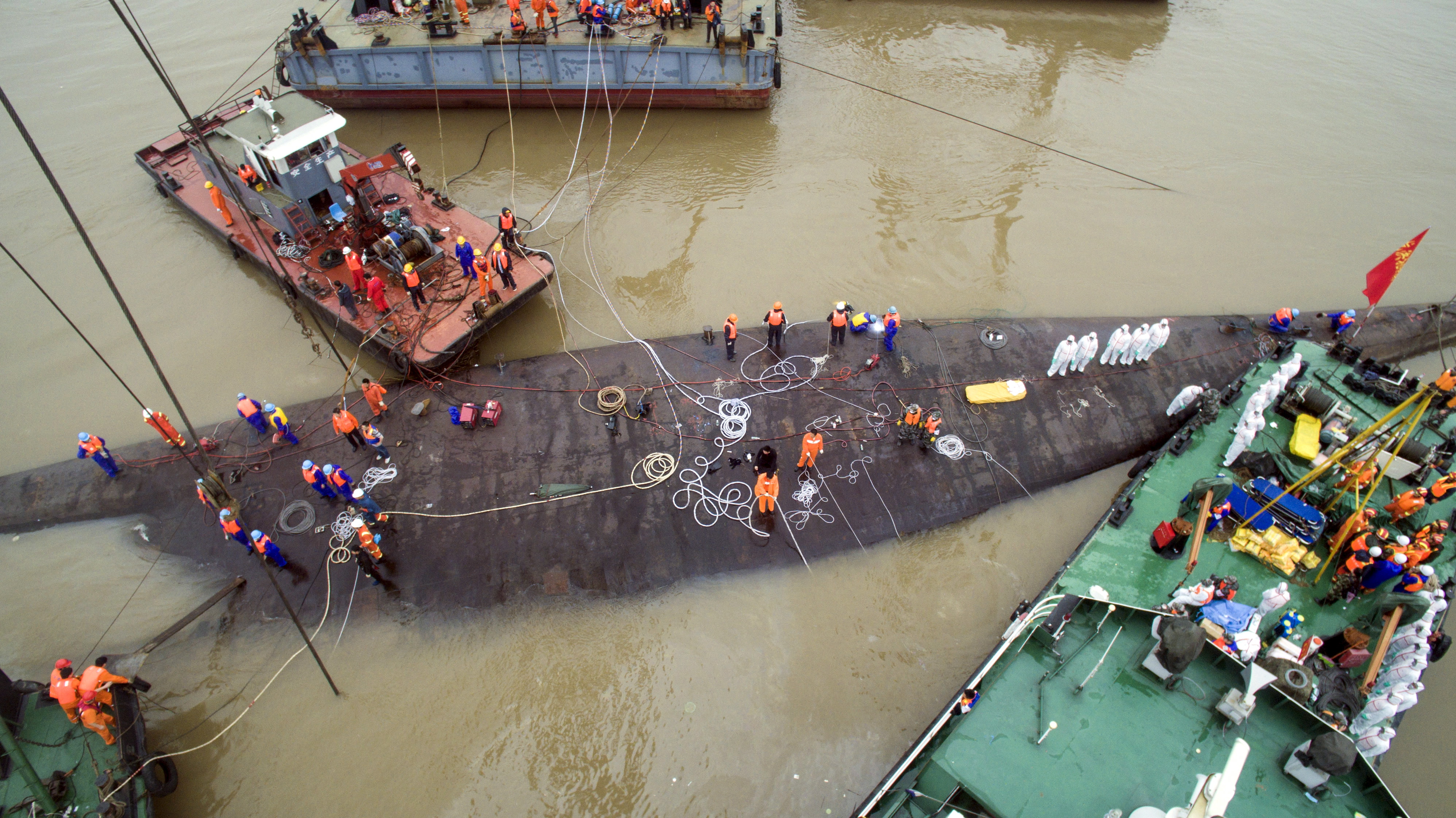 An aerial view shows rescue workers standing on the sunken cruise ship Eastern Star in Jianli
