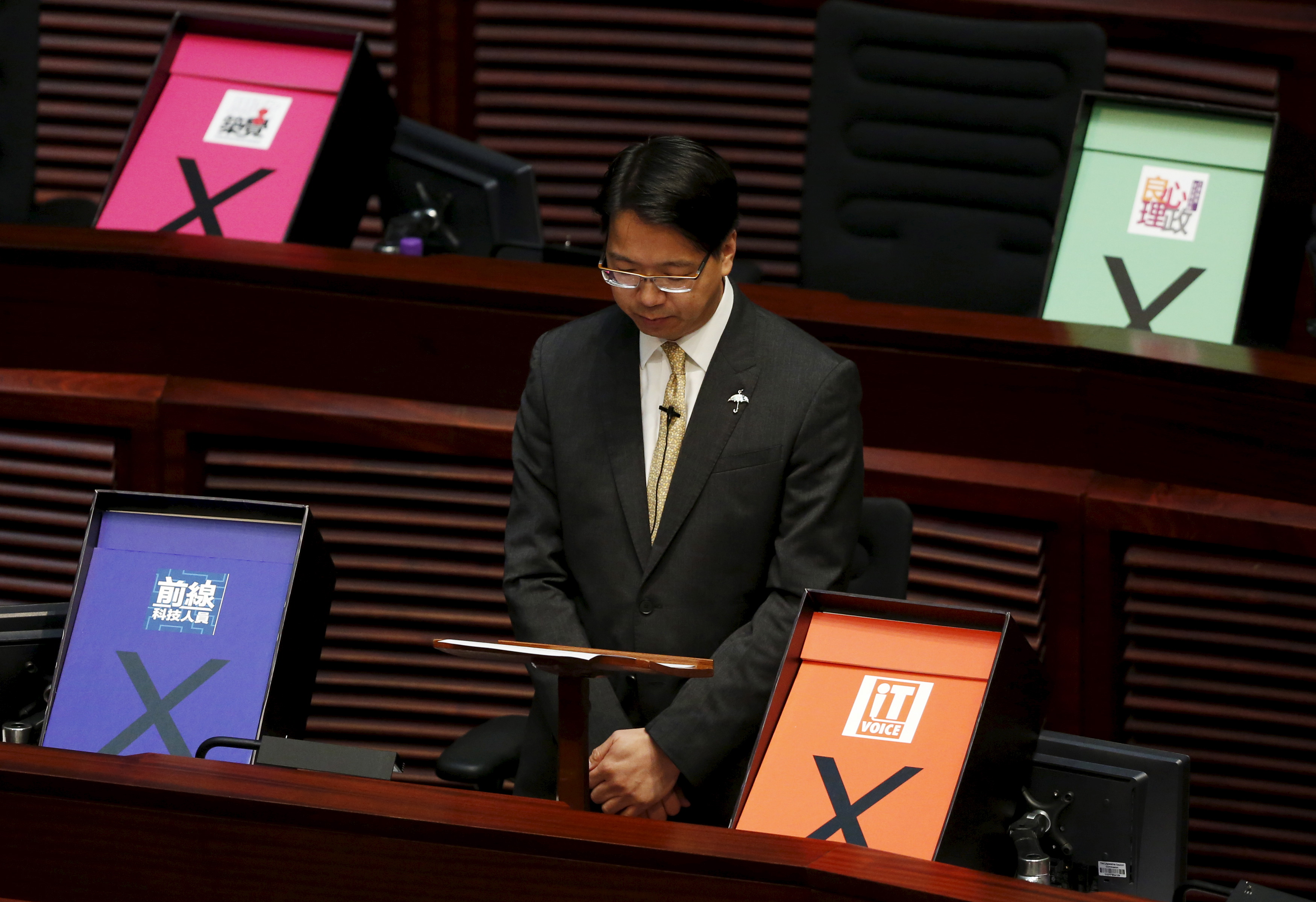 Pro-democracy lawmaker Charles Mok is surrounded by veto signs during his speech at the Legislative Council meeting in Hong Kong on June 18, 2015 (Bobby Yip—Reuters)