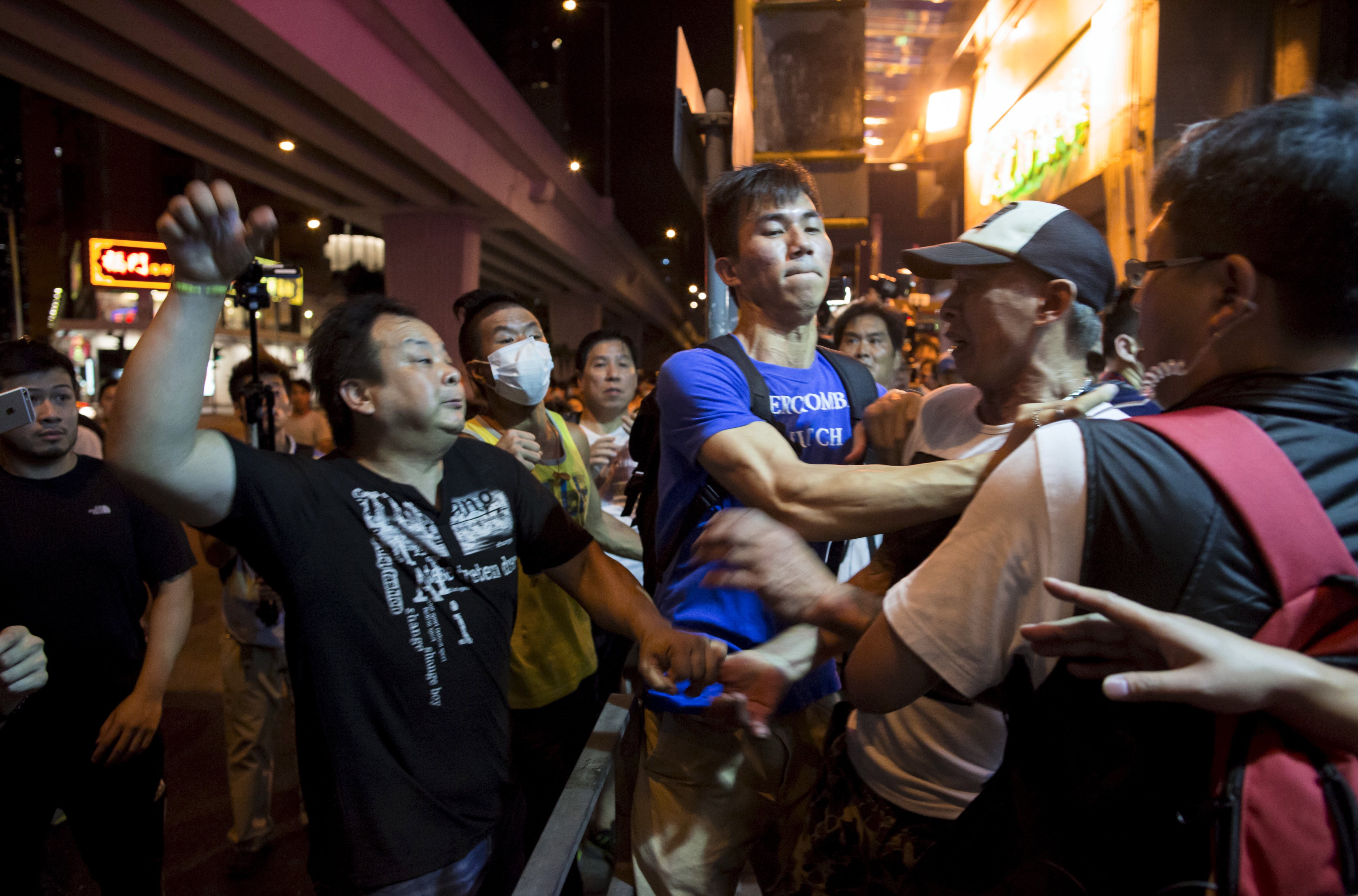 Localist protester scuffles with a pro-China demonstrator during an anti-China protest at Mongkok shopping district in Hong Kong, China