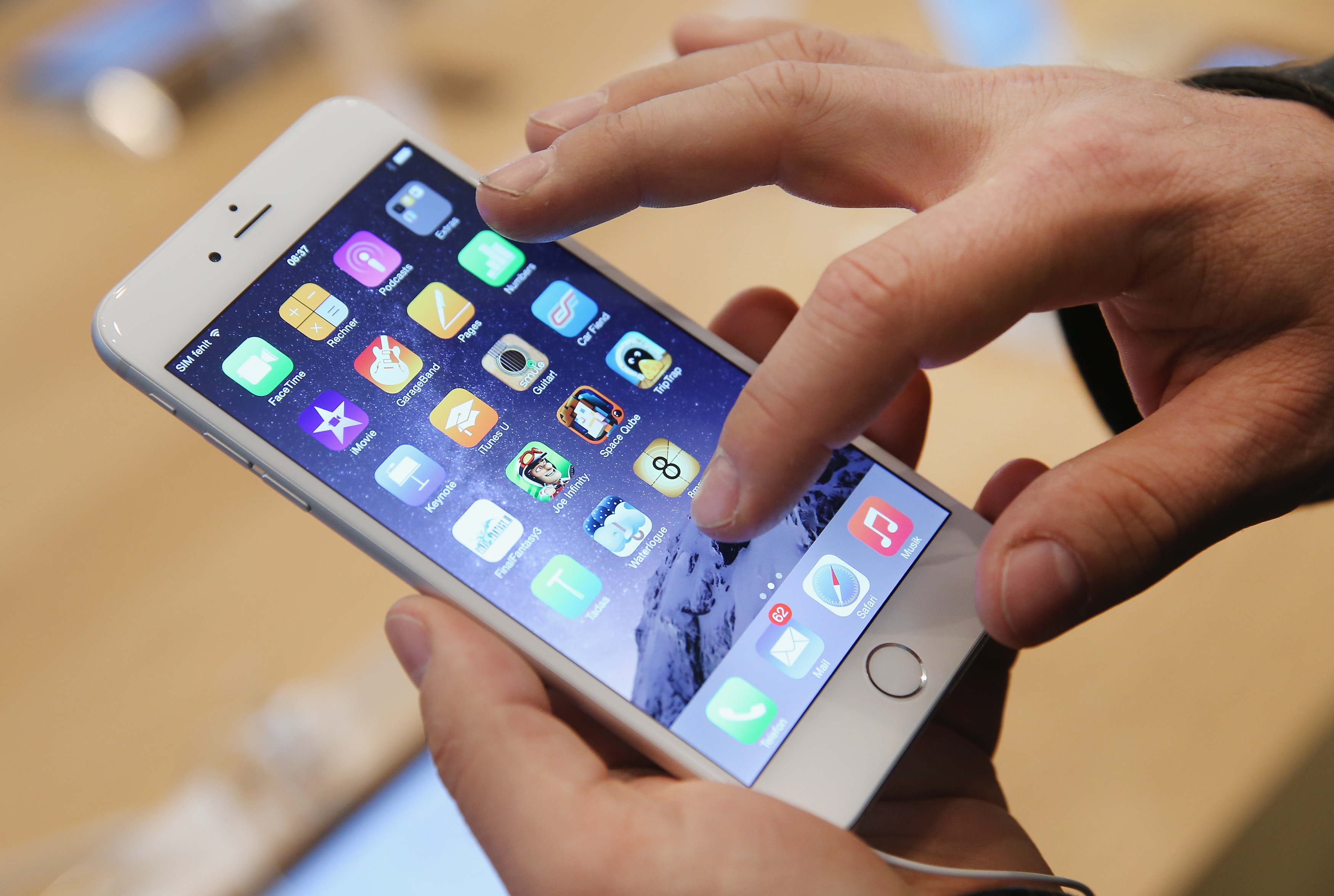 A shopper tries out the  Apple iPhone 6 at the Apple Store on the first day of sales of the new phone on Sept. 19, 2014 in Berlin, Germany. (Sean Gallup&mdash;Getty Images)