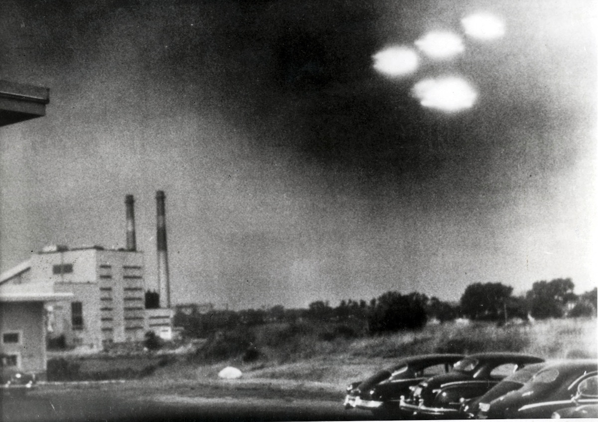 A picture, taken through the window of a laboratory by a U.S. coastguard, shows four unidentified flying objects as bright lights in the sky, in Salem, Mass. on Aug. 3, 1952. (Popperfoto / Getty Images)