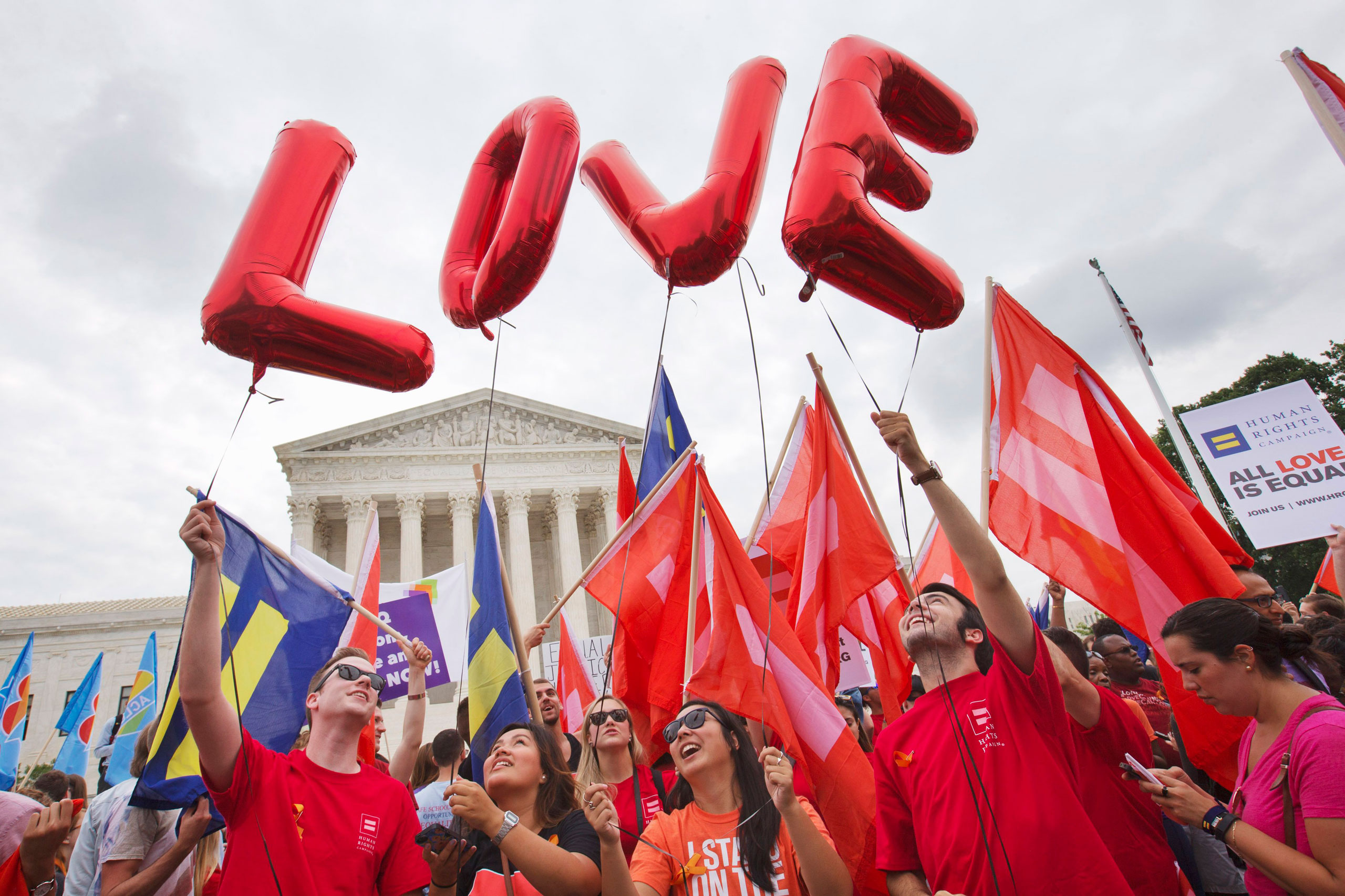Same-sex marriage supporters hold up balloons that spell the word "love" as they wait outside of the Supreme Court in Washington, on June 26, 2015, before the court declared that same-sex couples have a right to marry anywhere in the US. (Jacquelyn Martin&mdash;AP)