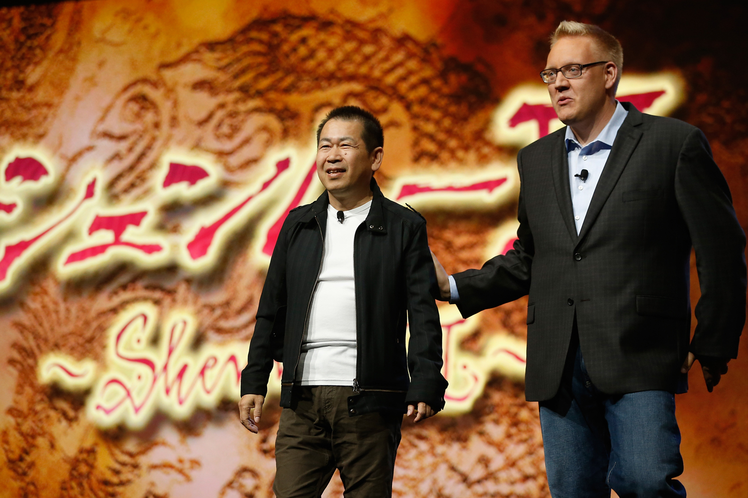 Game designer Yu Suzuki and Sony Computer Entertainment America vice president of publisher and developer relations, Adam Boyes discus "Shenmue 3" during the Sony E3 press conference at the  L.A. Memorial Sports Arena on June 15, 2015 in Los Angeles, California. (Christian Petersen — Getty Images)