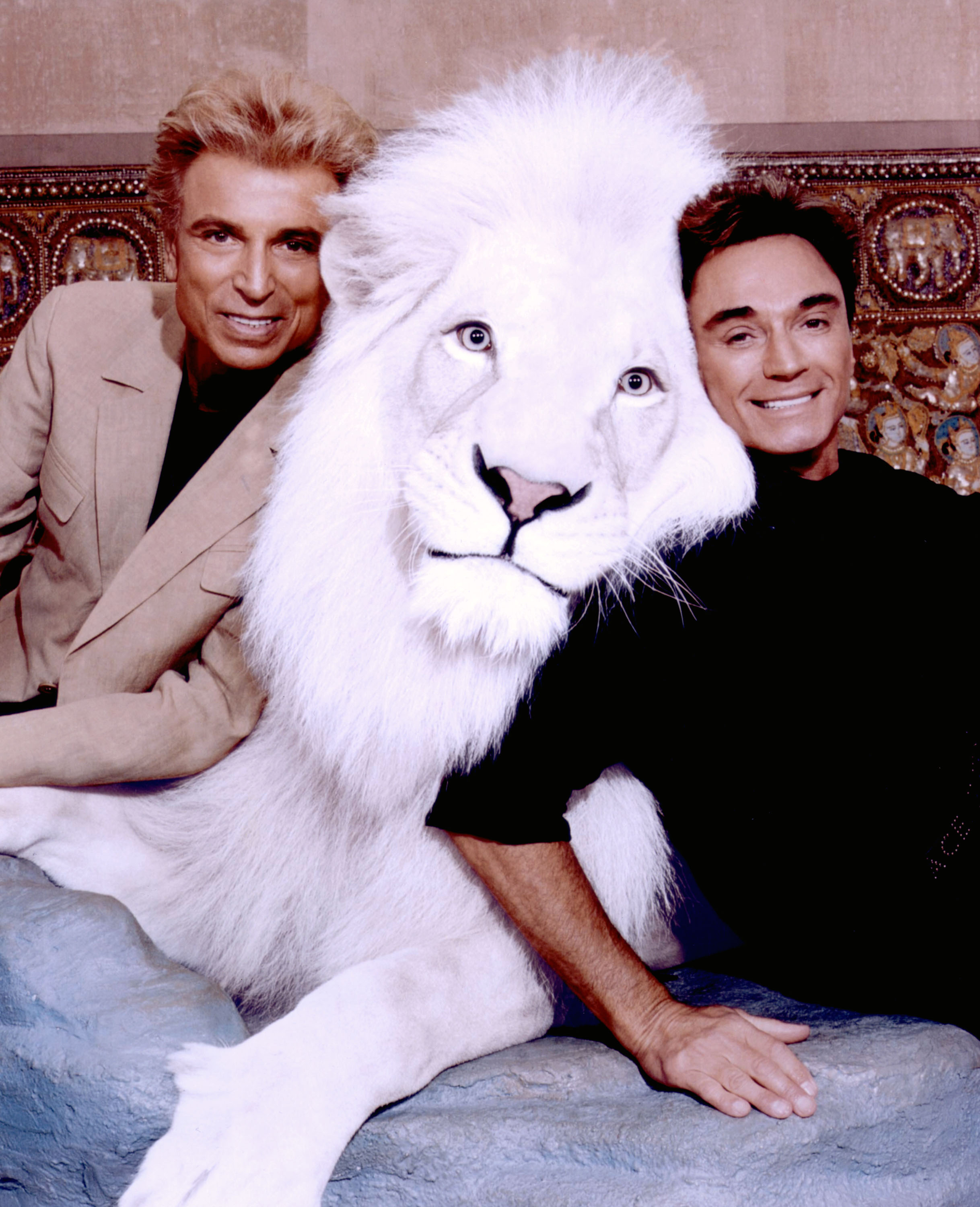 World-renowned illusionists and conservationists Siegfried &amp; Roy pose with Pride, the Magical White Lion in this undated photo. (Siegfried &amp; Roy—Getty Images)