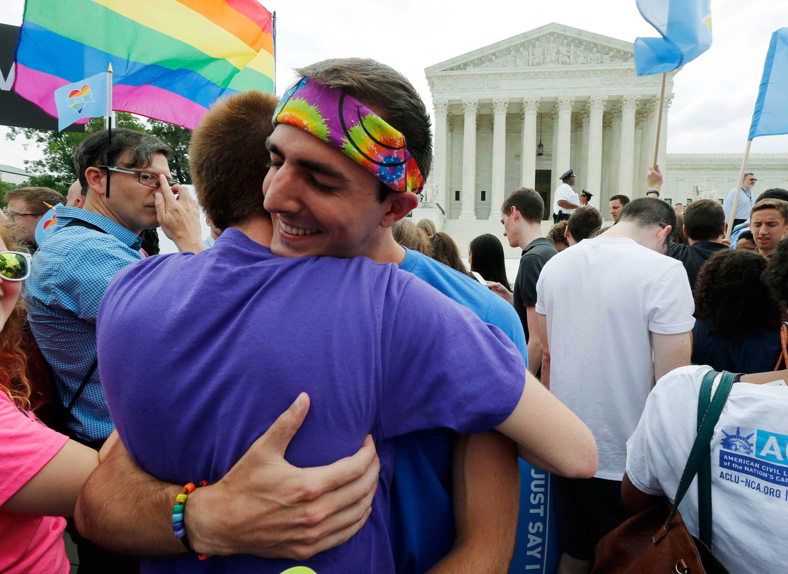 Gay rights supporters celebrate after the U.S. Supreme Court ruled that the U.S. Constitution provides same-sex couples the right to marry, outside the Supreme Court building in Washington, June 26, 2015.