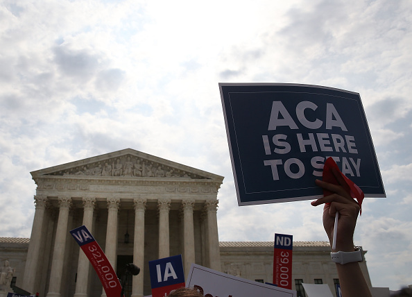 A sign is held up that reads "ACA Is Here To Stay" front of the US Supreme Court after ruling was announced in favor of the Affordable Care Act. June 25, 2015 in Washington, DC.