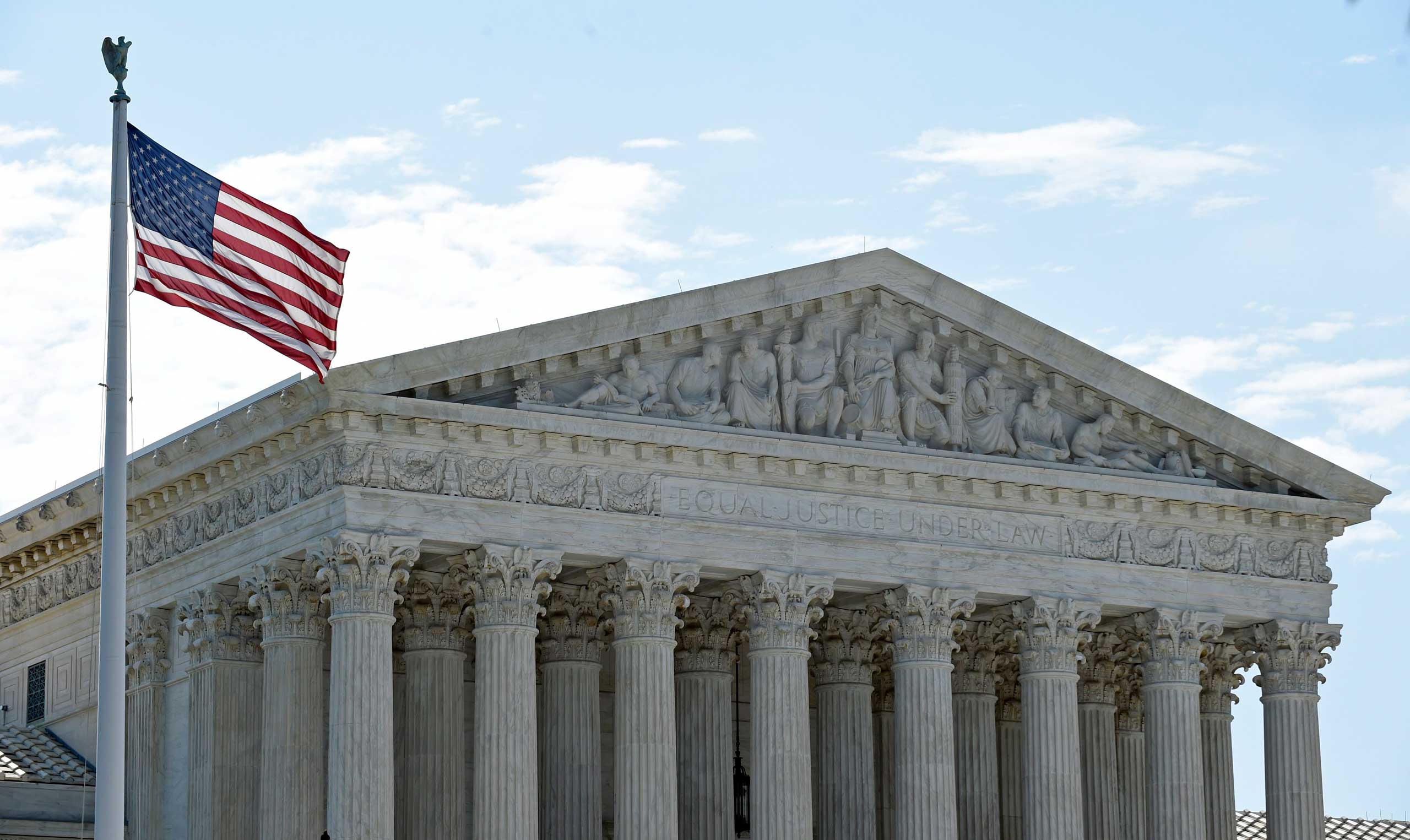 The American flag flies in the wind in front of the Supreme Court in Washington on June 22, 2015. (Susan Walsh—AP)