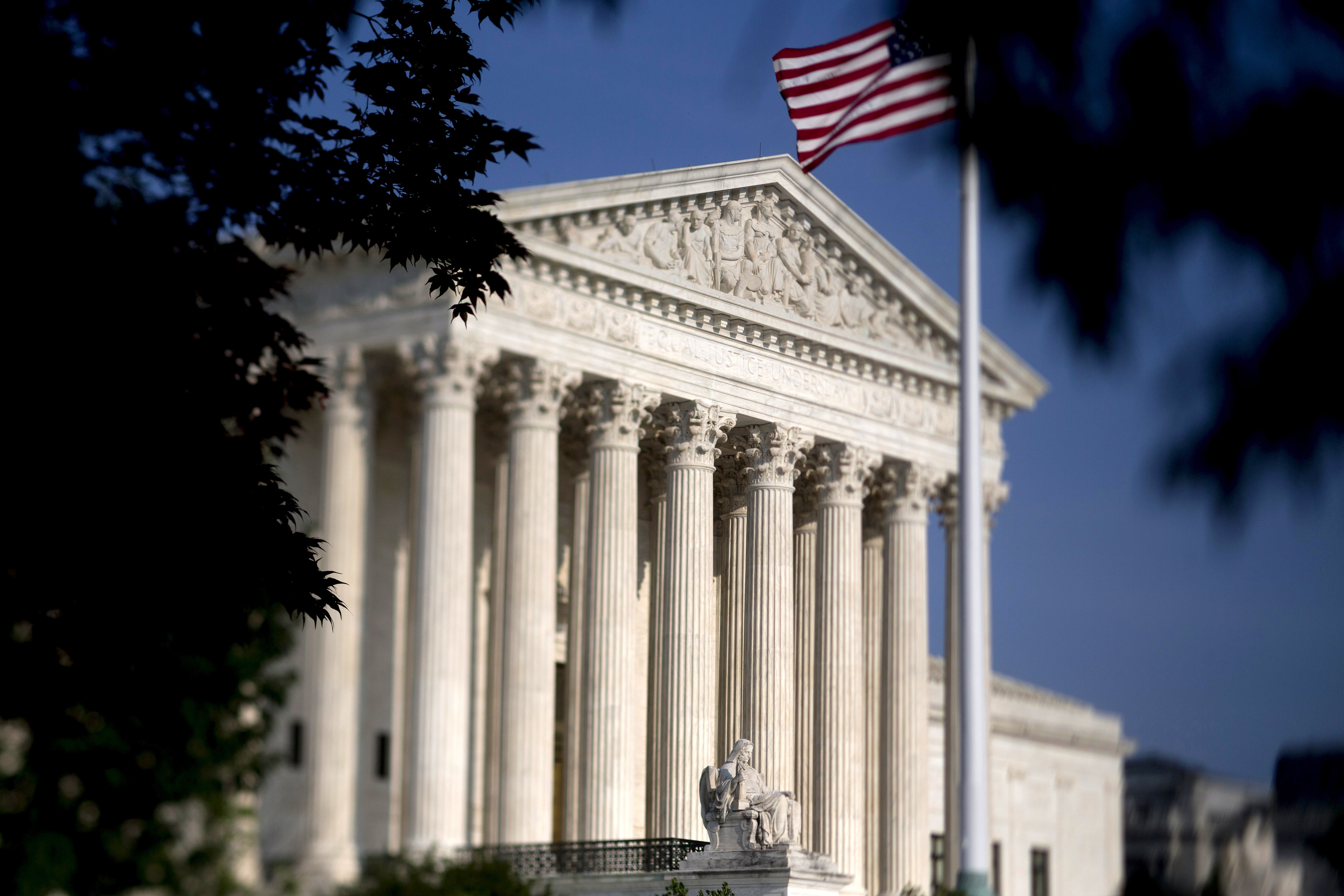 The American flag flies next to the U.S. Supreme Court. (Andrew Harrer—Bloomberg/Getty Images)