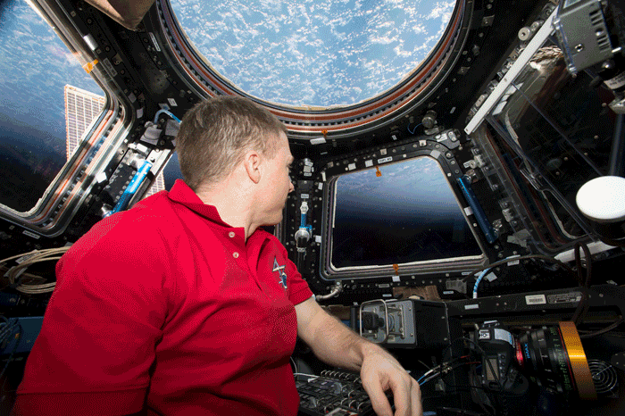 Astronaut Terry Virts photographing Earth aboard the International Space Station (NASA; GIF by Mia Tramz for TIME)
