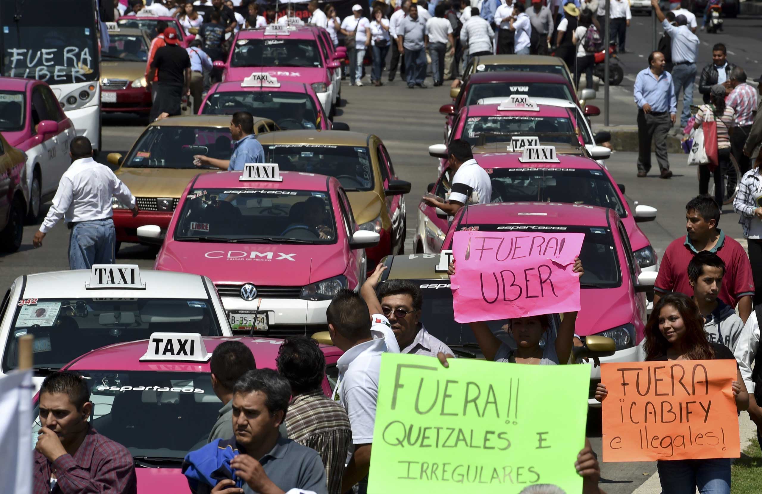 Taxi drivers take part in a protest against the private taxi company Uber for alleged unfair competition, in Mexico City on May 25, 2015. (Yuri Cortez—AFP/Getty Images)